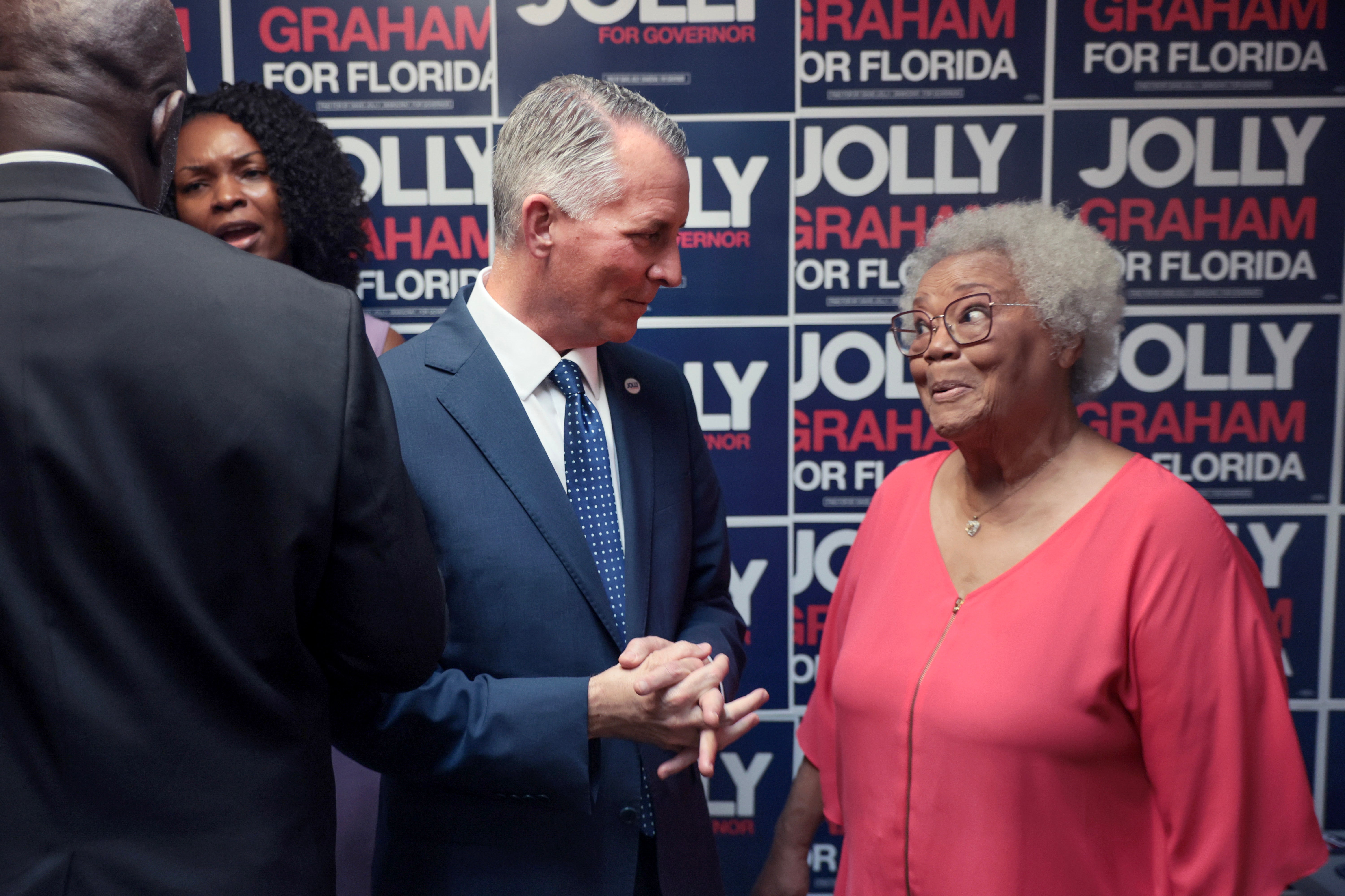 Democratic Florida gubernatorial nominee and former GOP House member David Jolly, center, speaks to supporter Elizabeth Judd while opening a campaign field office in Miami Gardens on Wednesday, September 23, 2026 (Getty)
