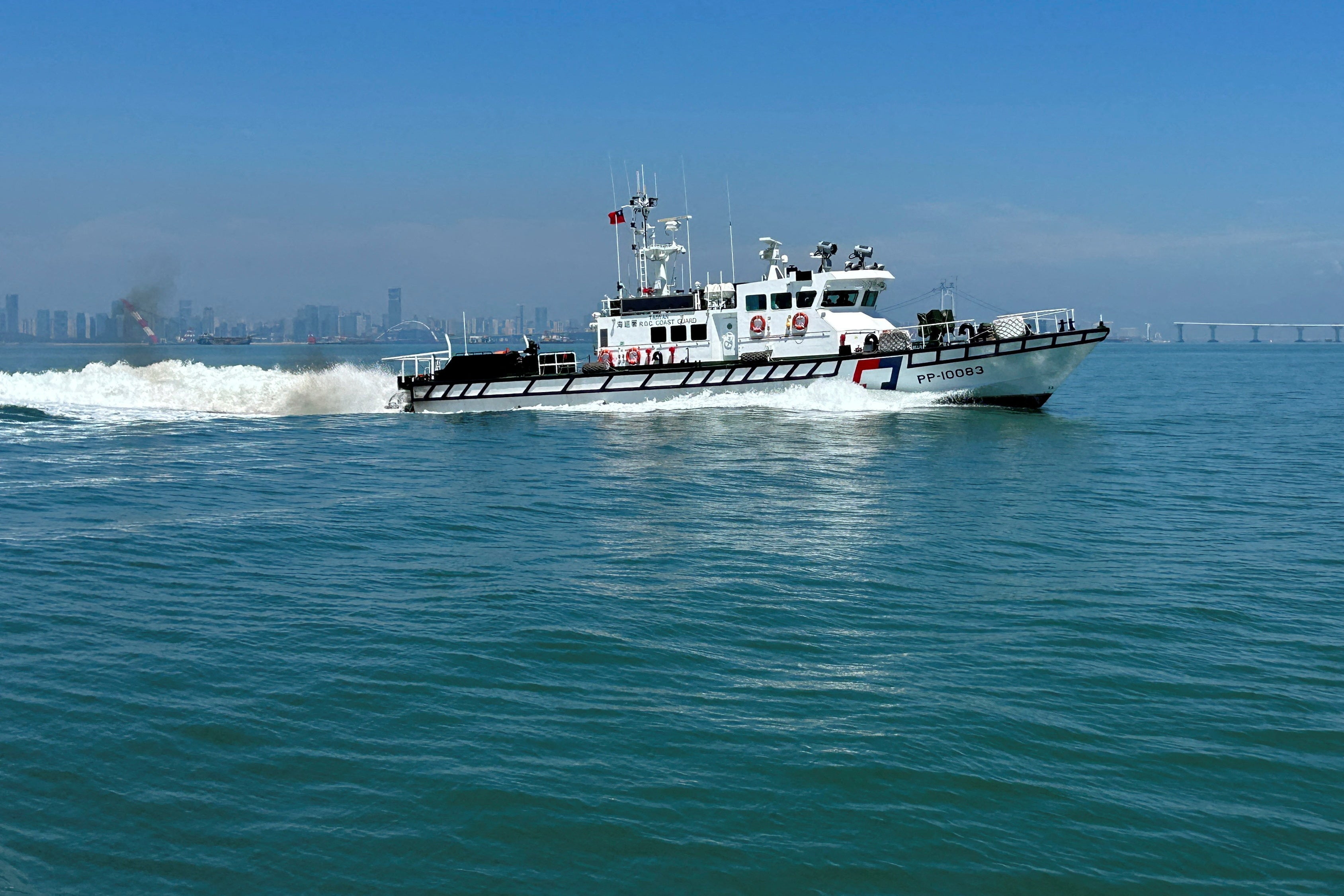File:  Taiwan Coast Guard ship patrols around Taiwan's Kinmen islands with the Chinese coast visible in the background (Reuters)