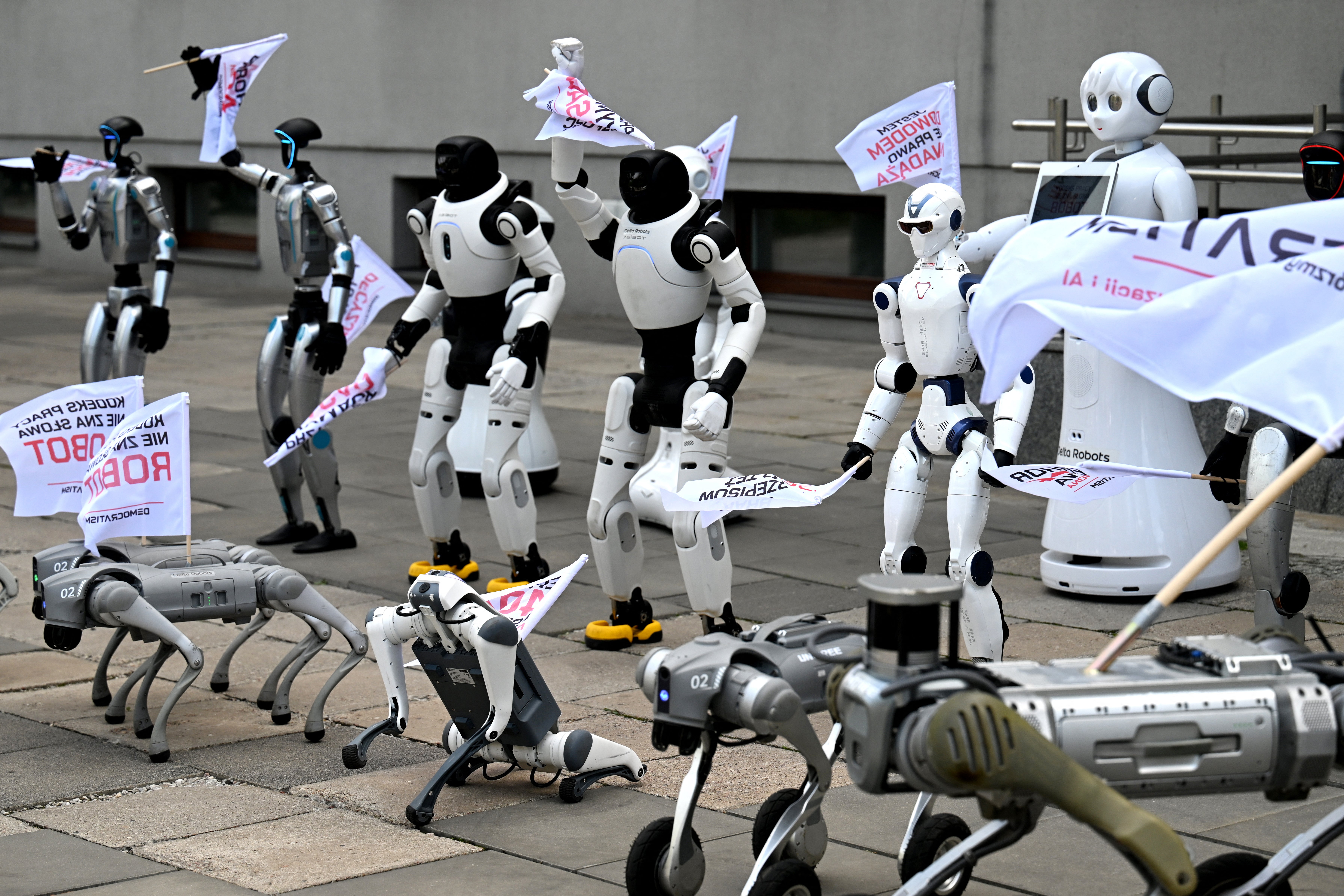 Humanoid and quadruped robots during a demonstration calling for the regulation of artificial intelligence development