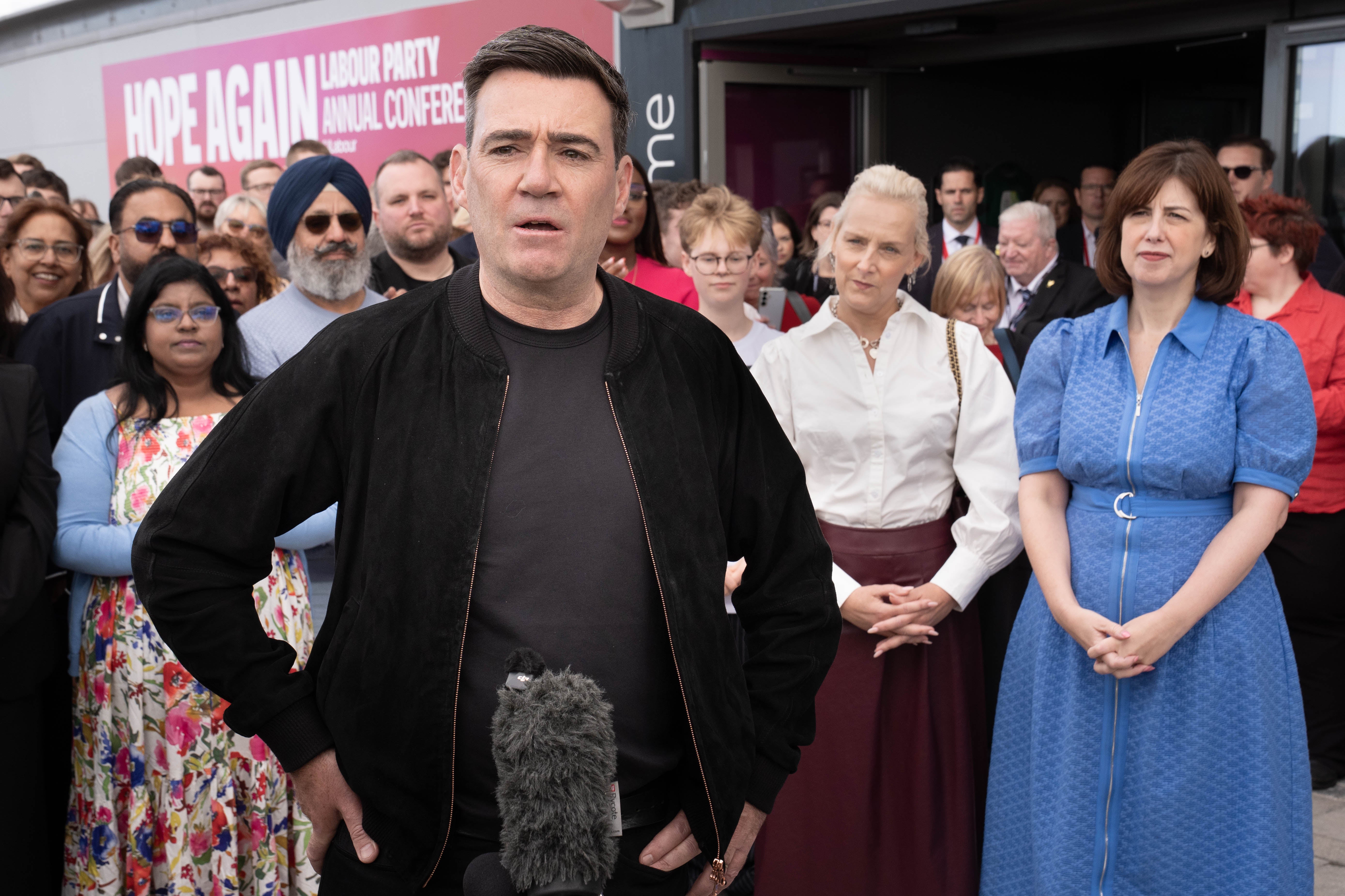 Andy Burnham speaks to the media as he and his wife Marie-France Van Heel arrive for the Labour Party Conference at the ACC Liverpool