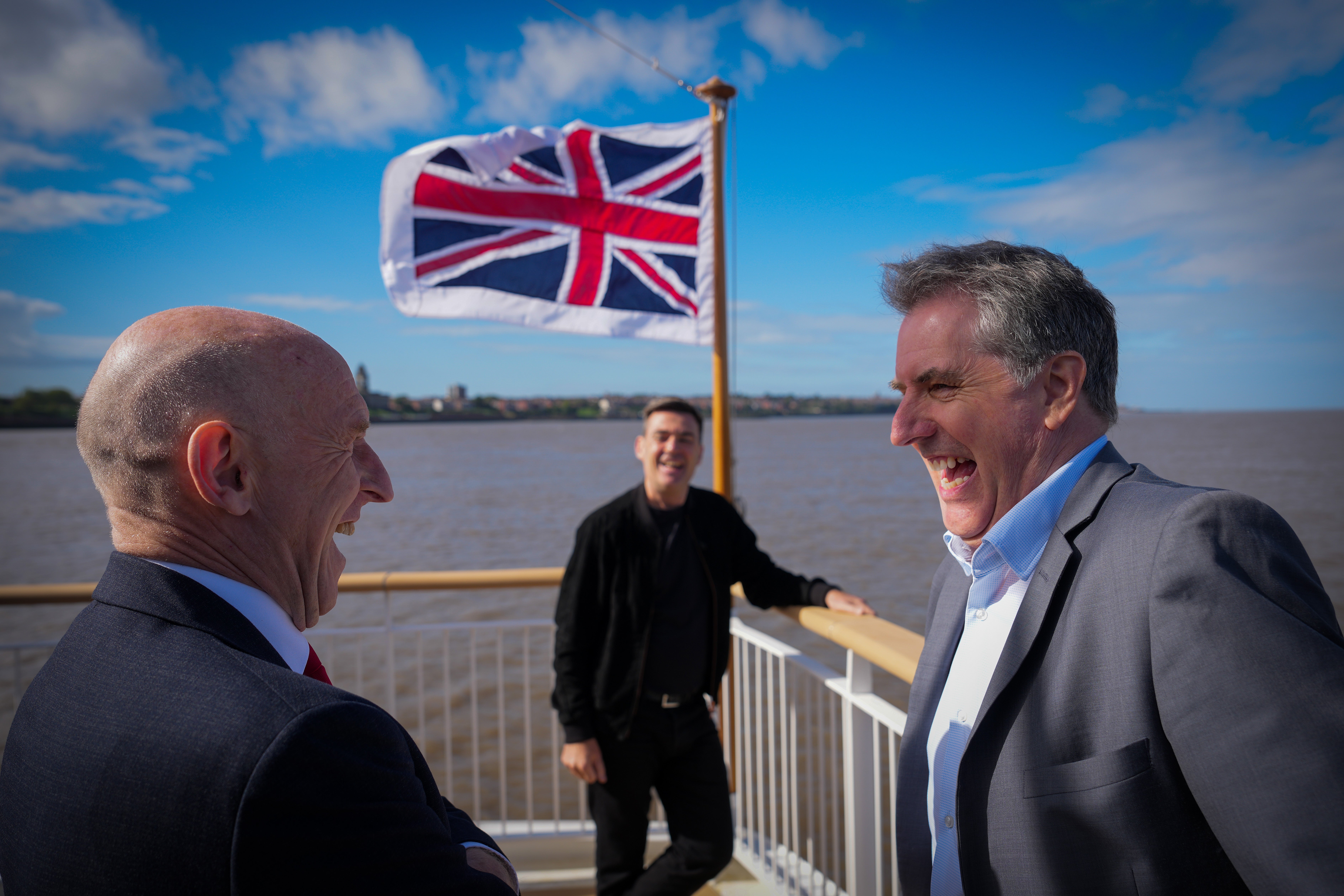 Liverpool City Region mayor Steve Rotheram (R), Andy Burnham and the chancellor of the exchequer, John Healey (L) share a joke as they travel on the new Royal Daffodil Mersey ferry