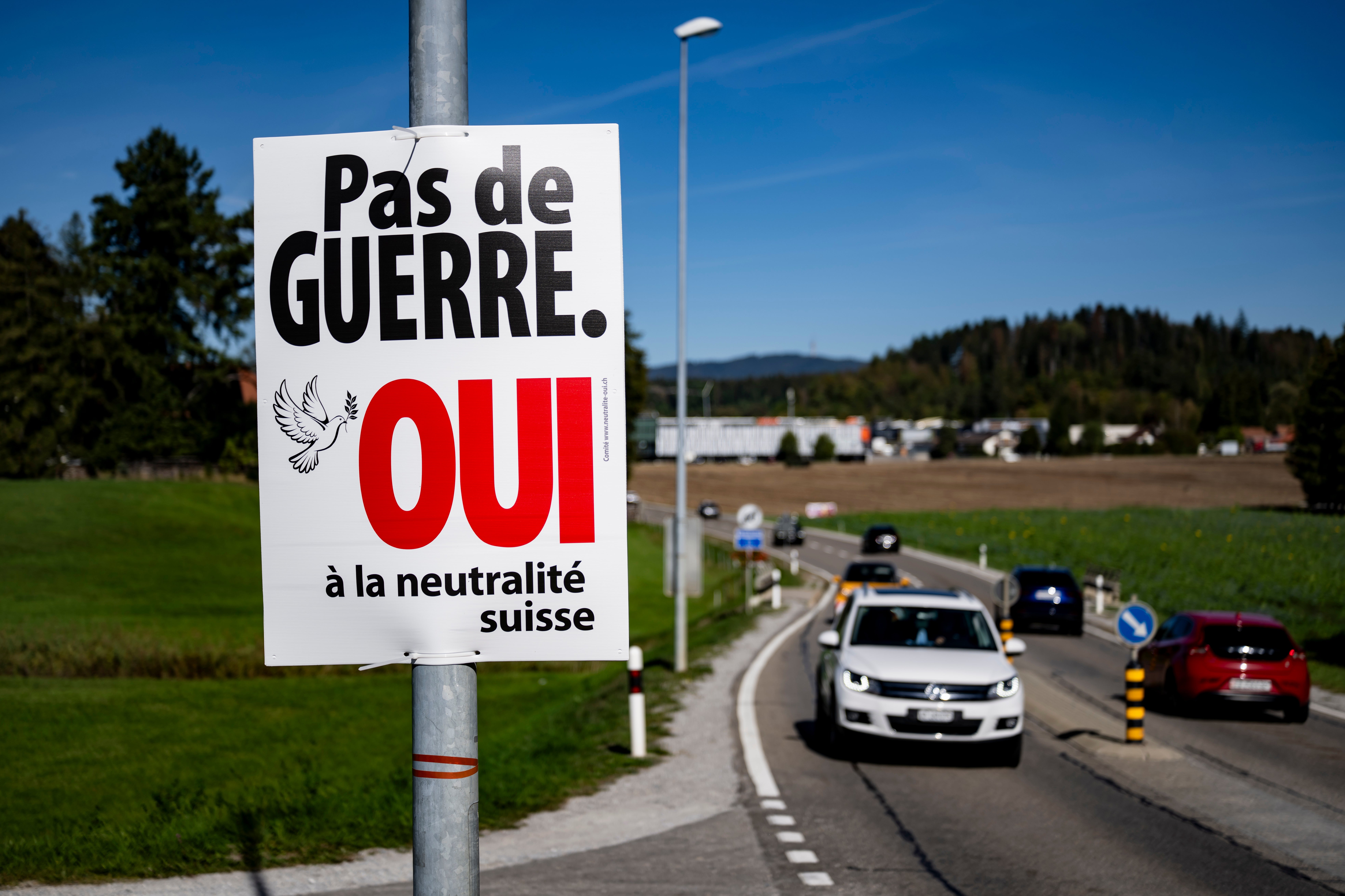 An electoral poster reading ‘No war, Yes to Swiss neutrality’ is posted along a road in Epagny, Switzerland, on 25 September 2026