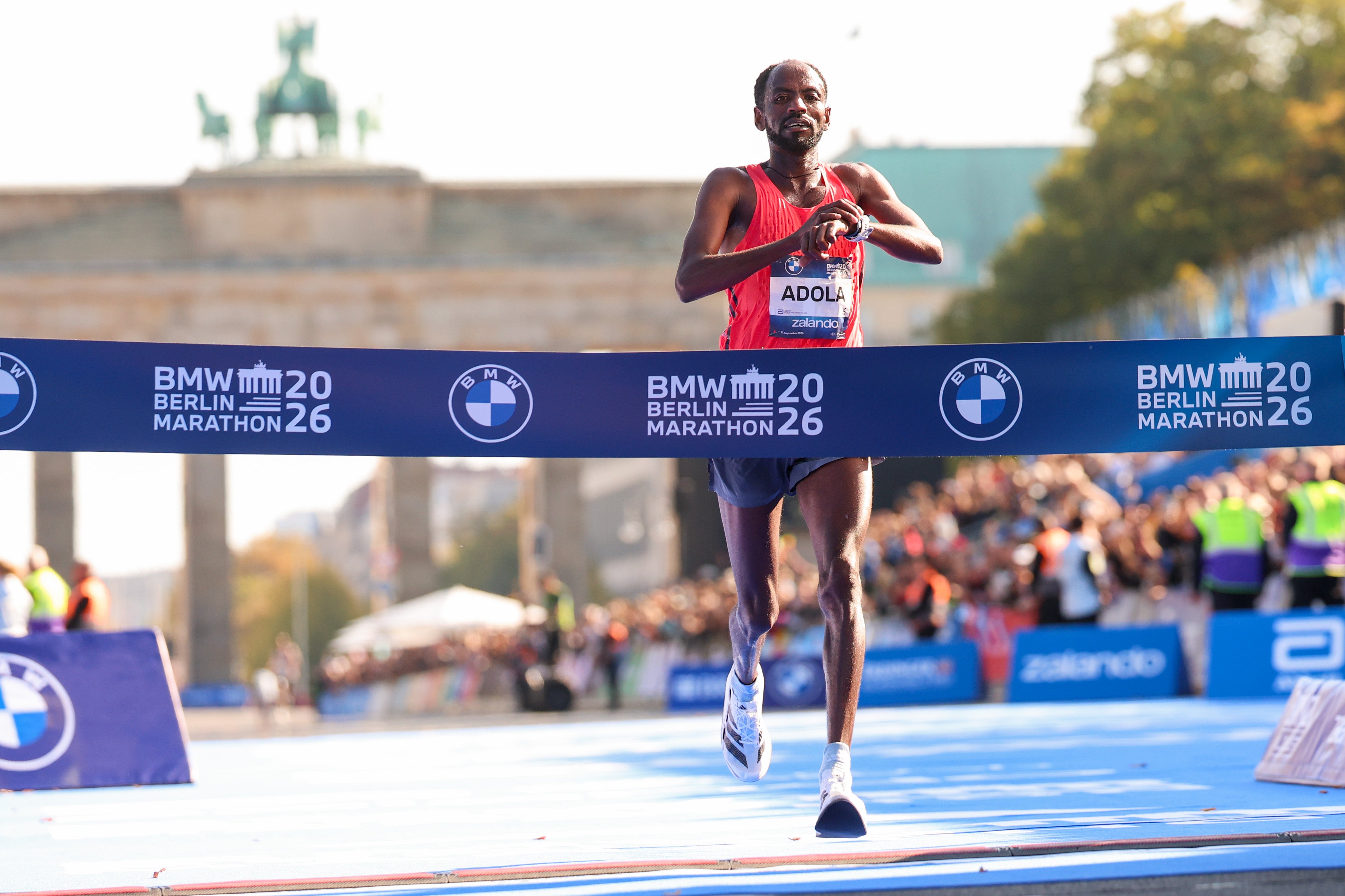 Guye Adola from Ethiopia celebrates crossing the line