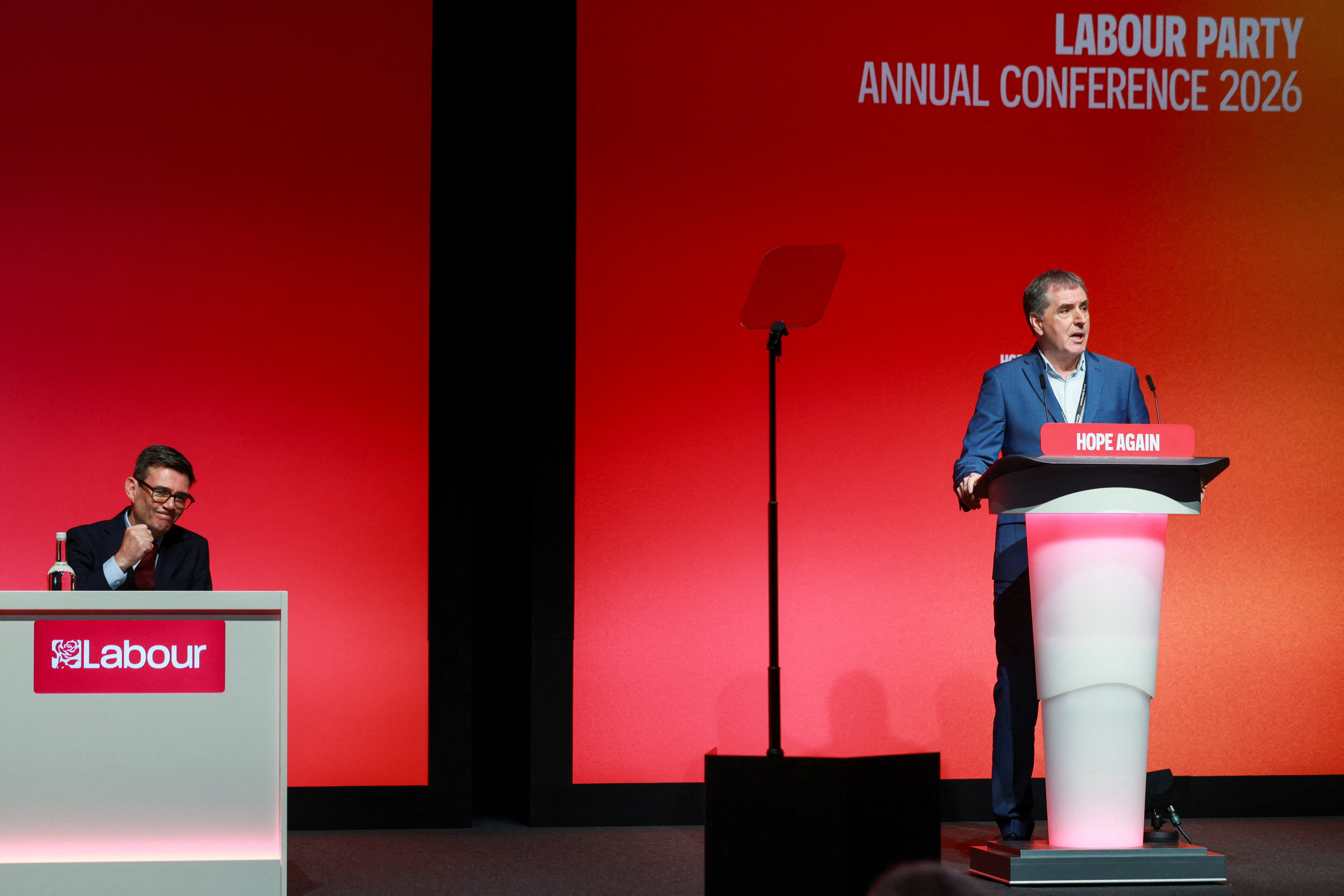 Andy Burnham gestures as mayor of the Liverpool City Region, Steve Rotheram, speaks during the Britain's Labour Party's annual conference