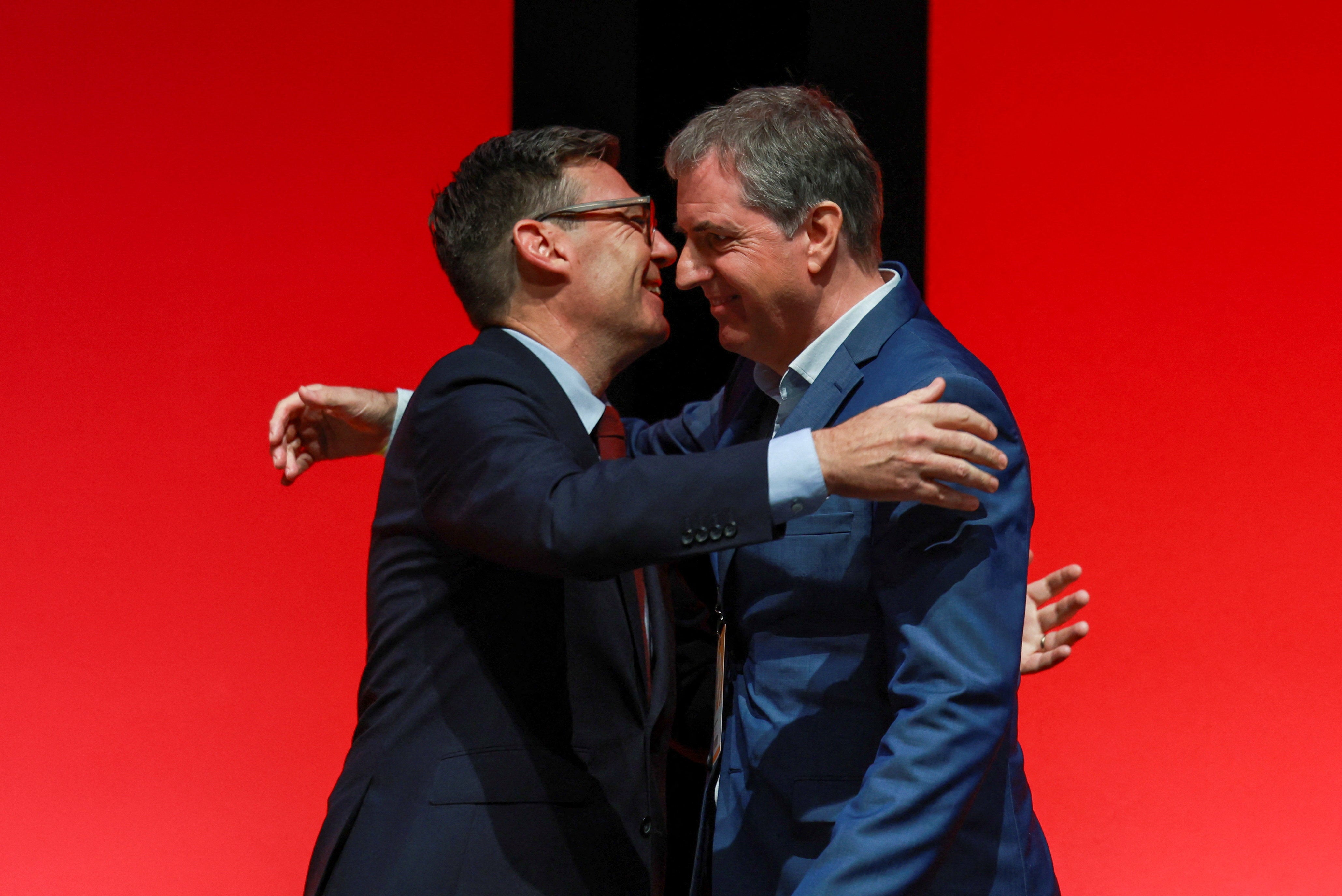 Andy Burnham hugs mayor of the Liverpool City Region, Steve Rotheram, during the Britain's Labour Party's annual conference in Liverpool