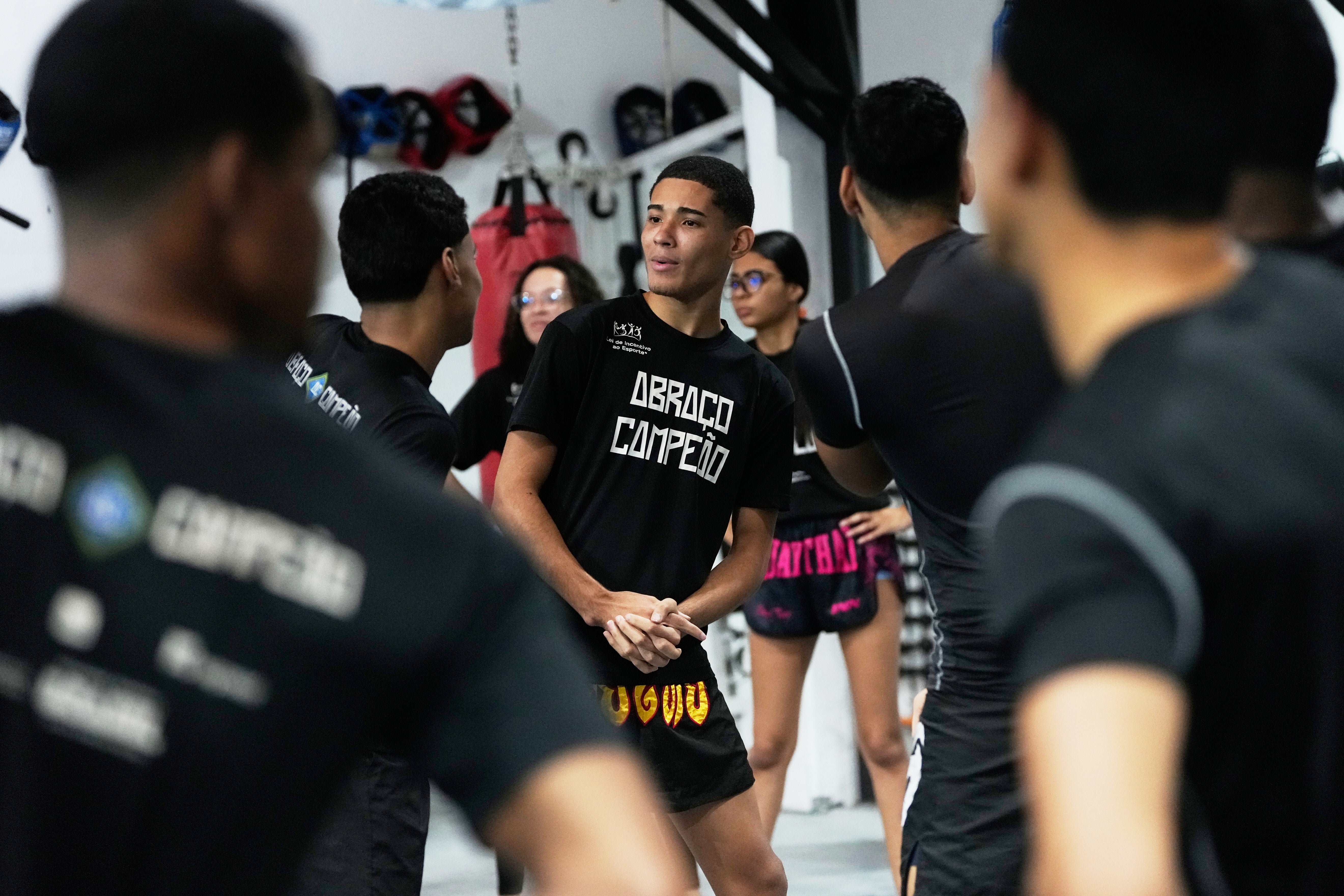 Youth attend a martial arts class at Abraco Campeao, or Embrace Champions, an academy that offers free boxing, jiu-jitsu, Muay Thai and capoeira classes, as well as educational talks on topics ranging from environmental issues to relationships, in the Complexo de Alemao favela in Rio de Janeiro, Wednesday, Sept. 16, 2026