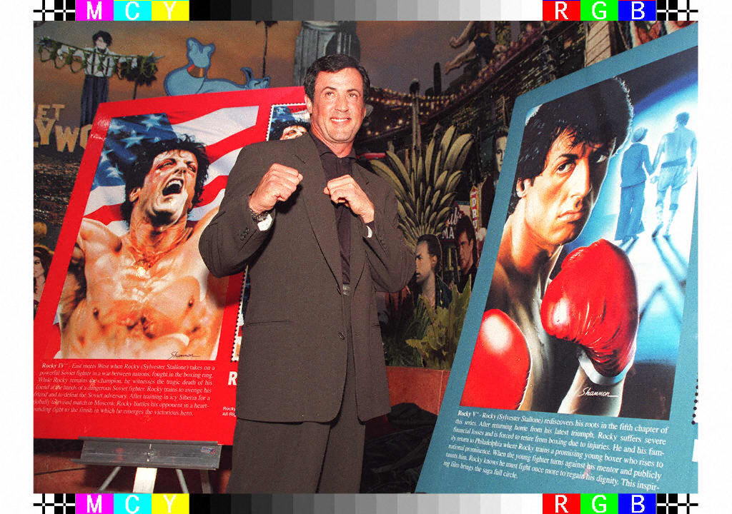 Sylvester Stallone poses with posters of the film ‘Rocky’ (AFP/Getty)