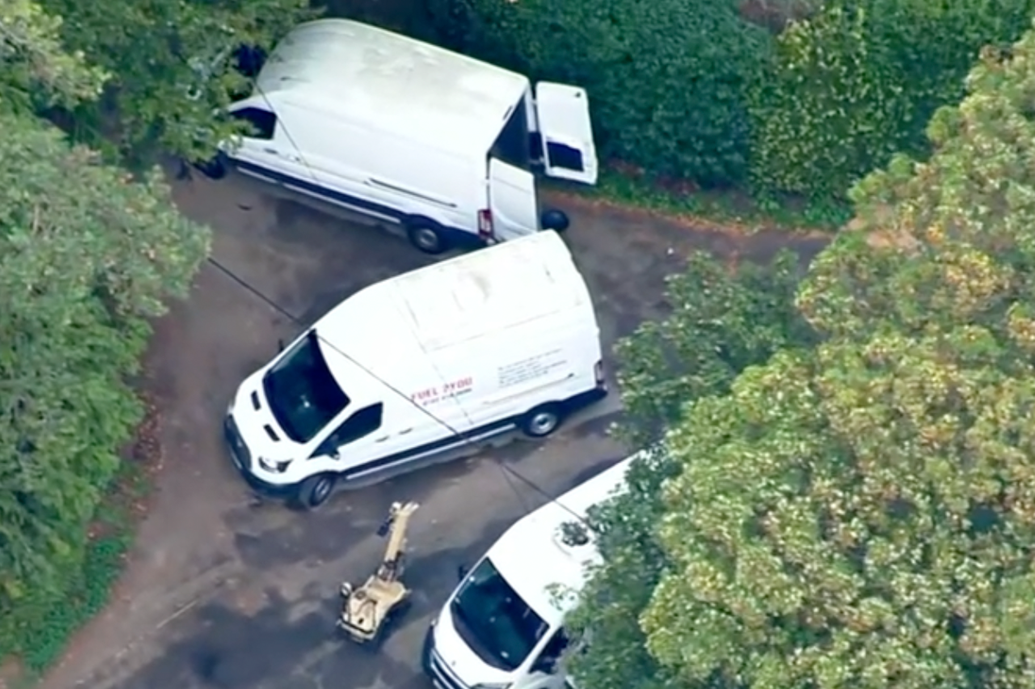 Three white vans were being examined by a bomb squad robot