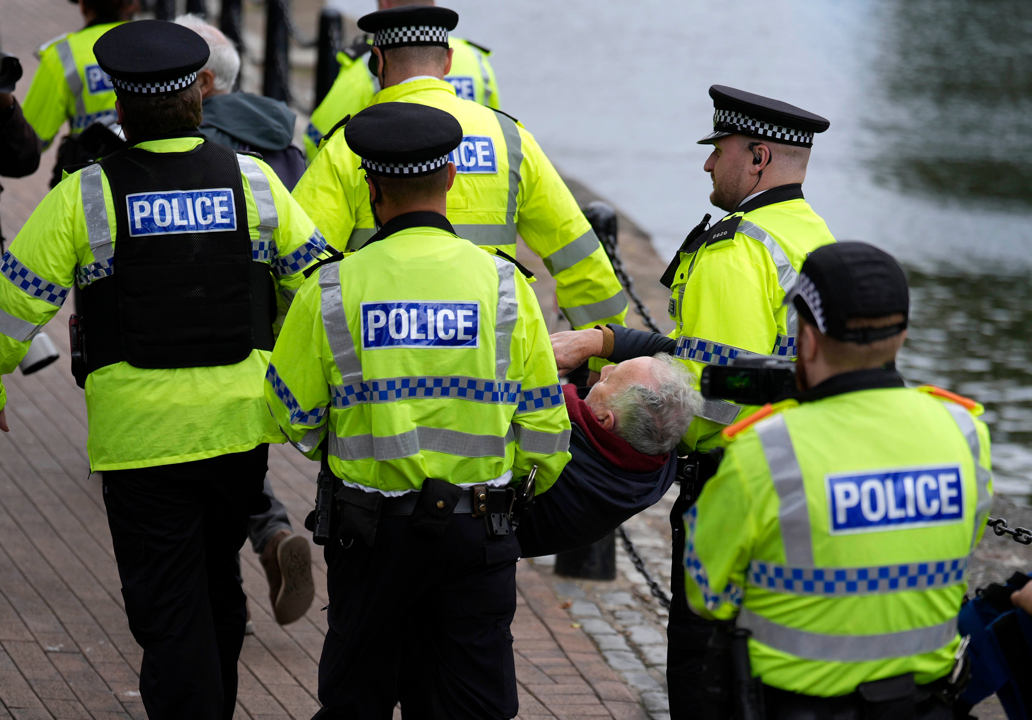 Police remove a demonstrator at a protest in support of Palestine Action at Labour conference