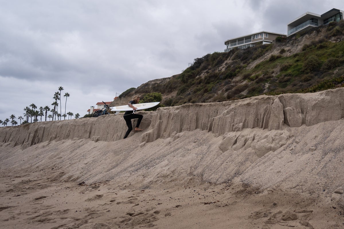 Sea level rise is reshaping a beloved California beach town and threatening a busy rail line