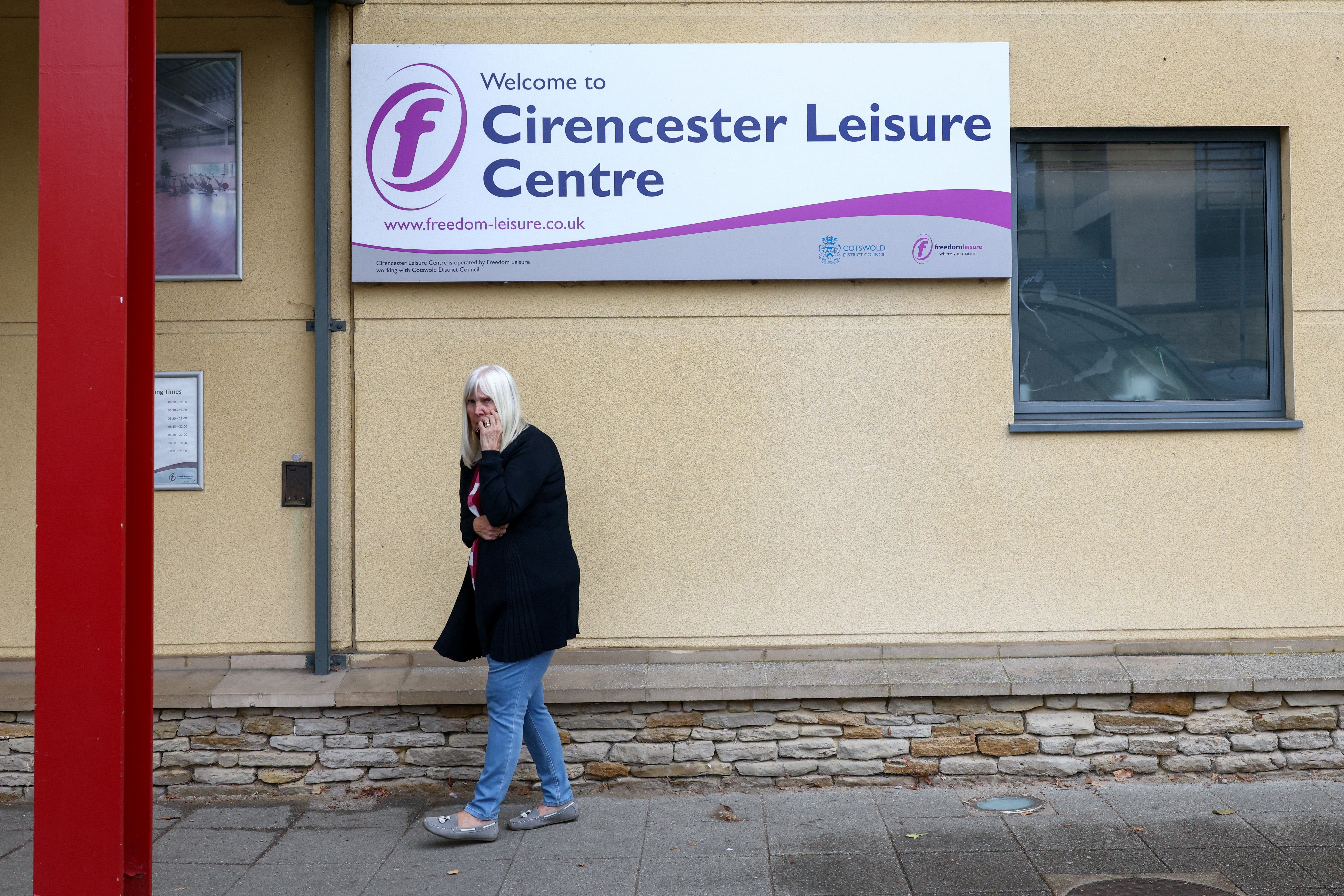 An evacuated resident walks at Cirencester Leisure Centre