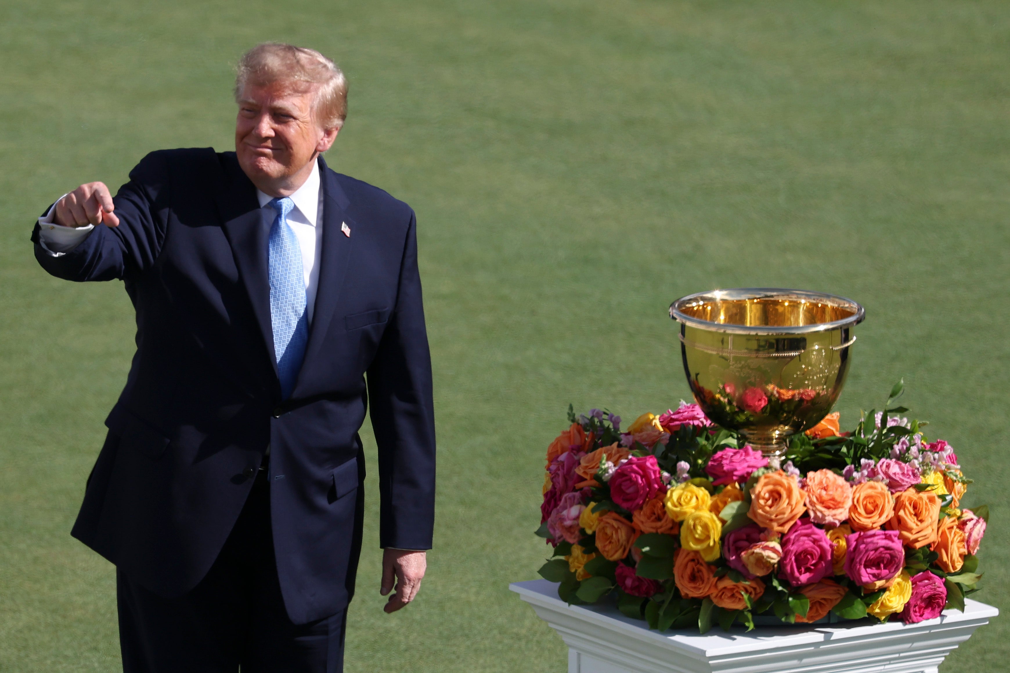 U.S. President Donald Trump reacts to the crowd on the first tee (Getty)