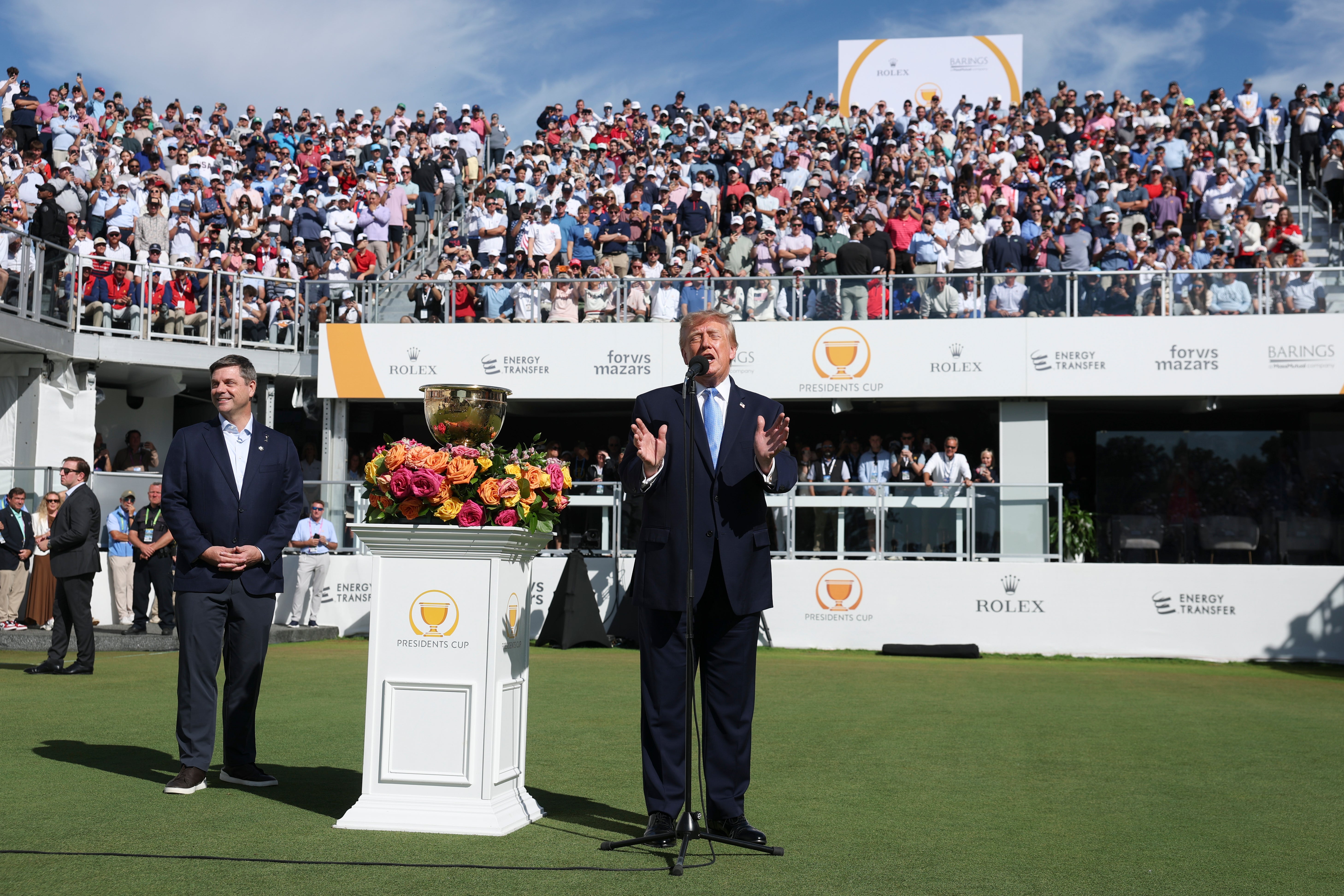 U.S. President Donald Trump speaks as CEO of PGA Tour Brian Rolapp looks on (Getty)