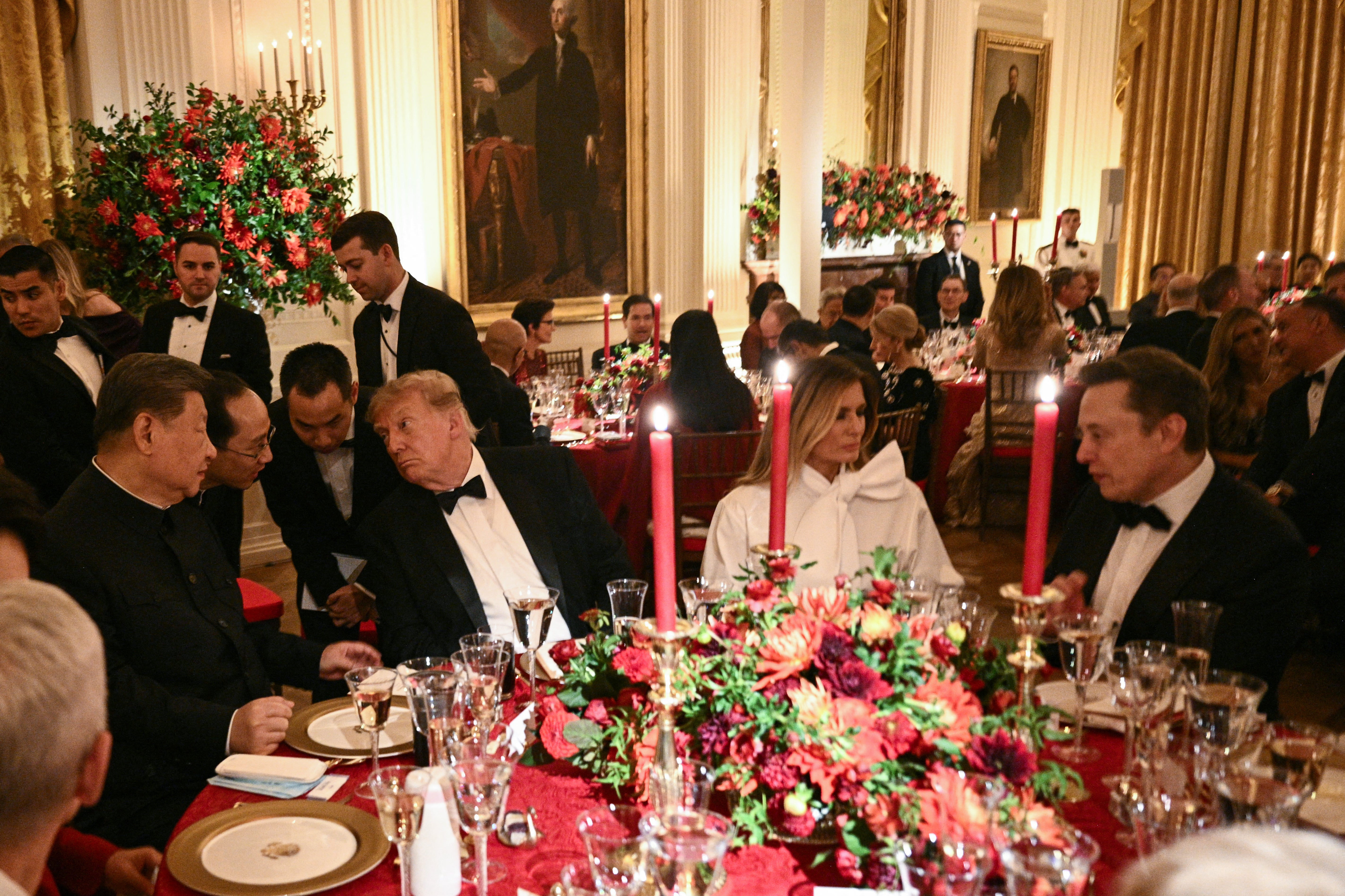 China's President Xi Jinping and President Donald Trump speak through interpreters while First Lady Melania Trump talks with Tesla CEO Elon Musk at a State Dinner in Washington, D.C. last week (AFP/Getty)