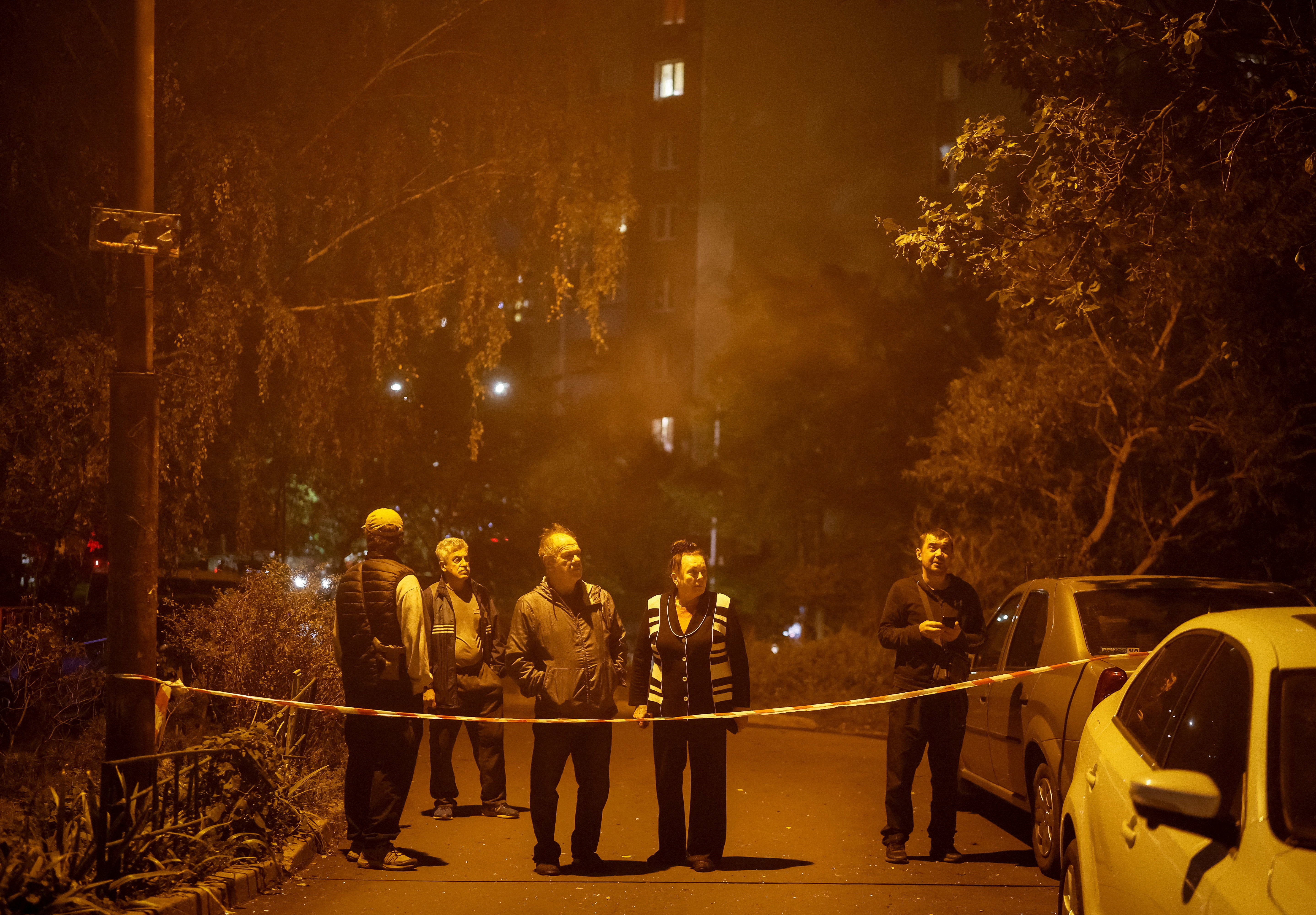 Residents stand at the site of an apartment building damaged by a Russian jet drone strike, amid Russia's attack on Ukraine in Kyiv, Ukraine 27 September 2026 (Reuters)