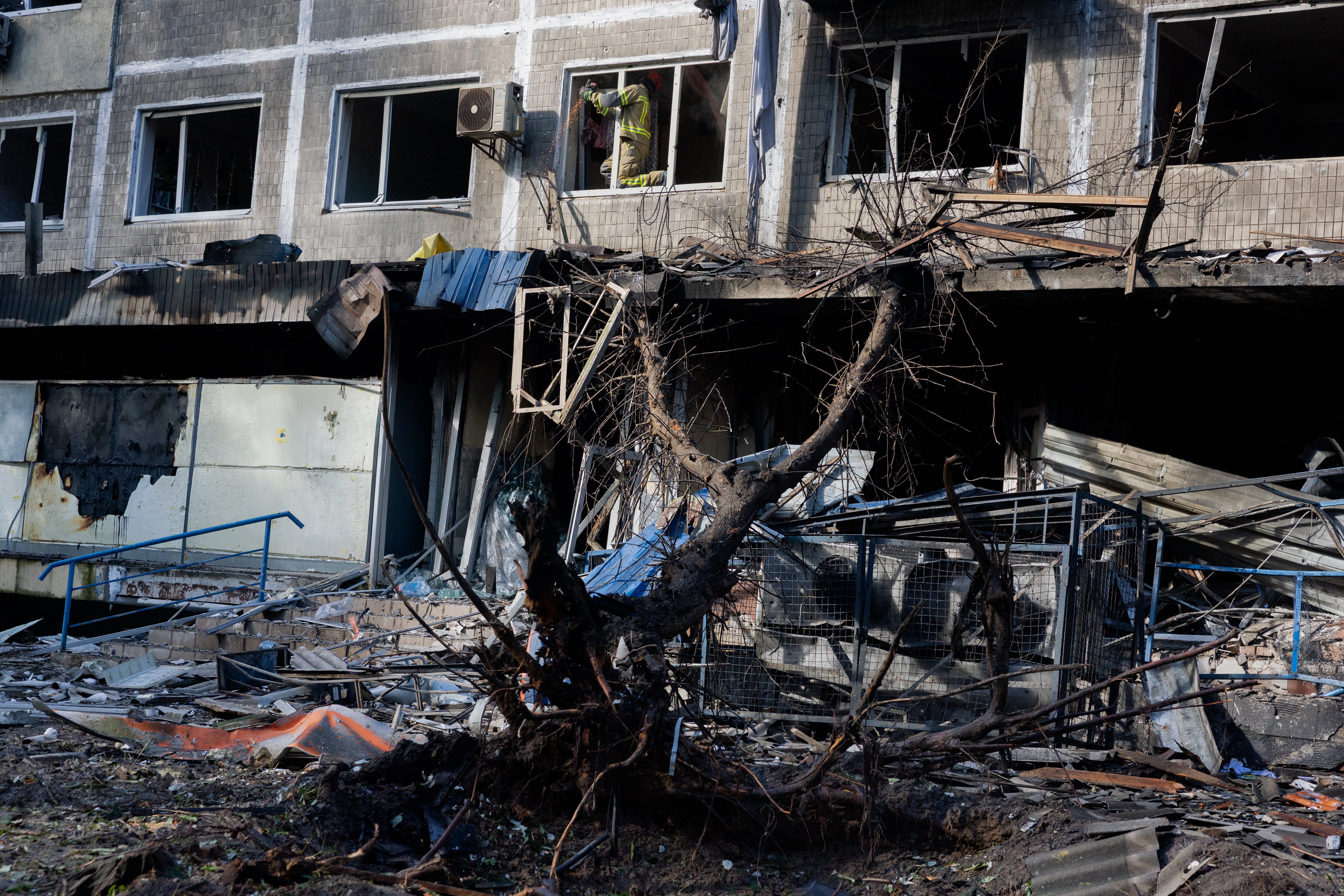 Rescue workers are seen at the site of a damaged residential building  following a drone strike in Kyiv on 26 September 2026 (AFP/Getty)