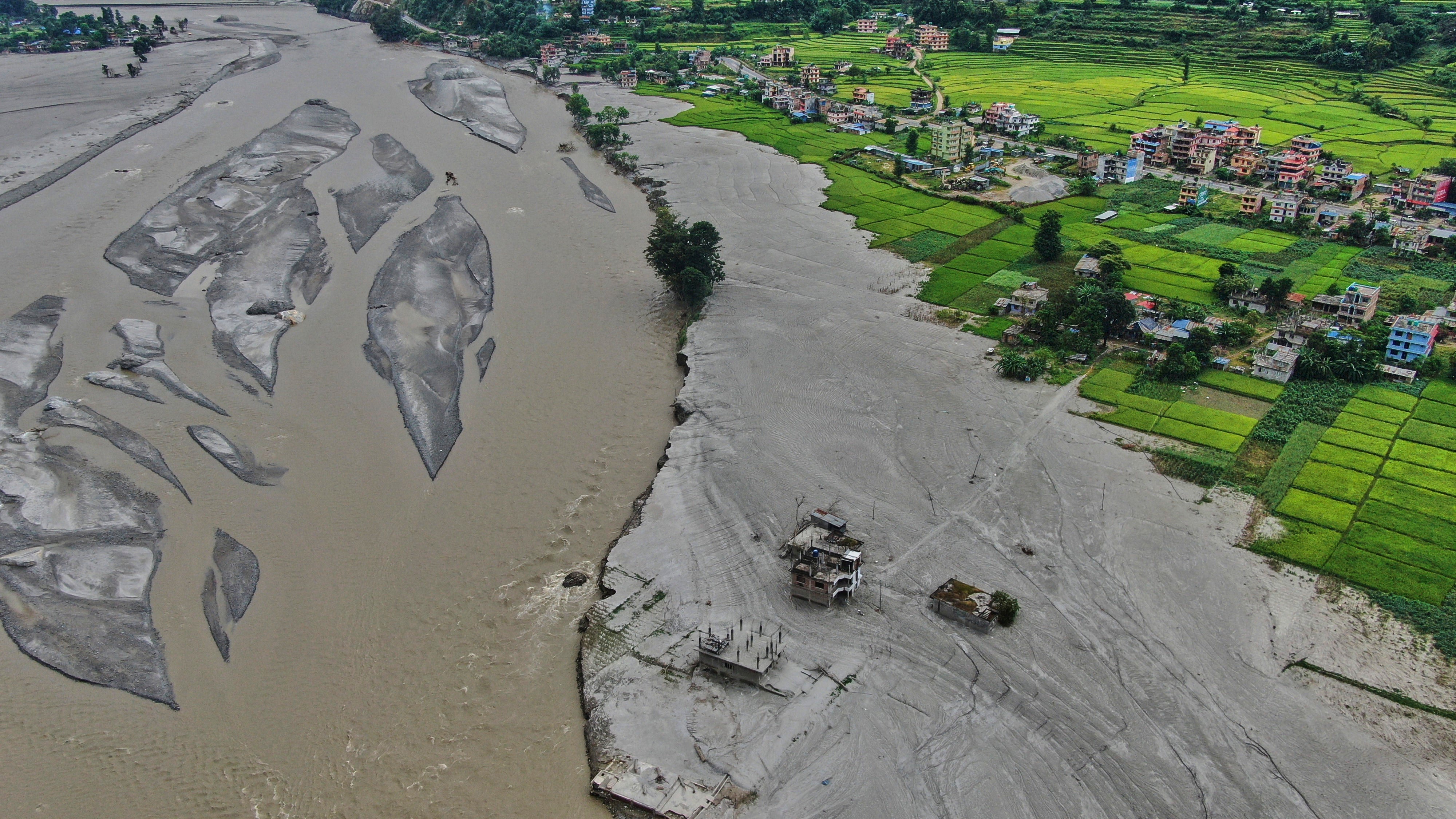 Farmland lies covered in mud after flash floods in Galchi in Nepal (AP)