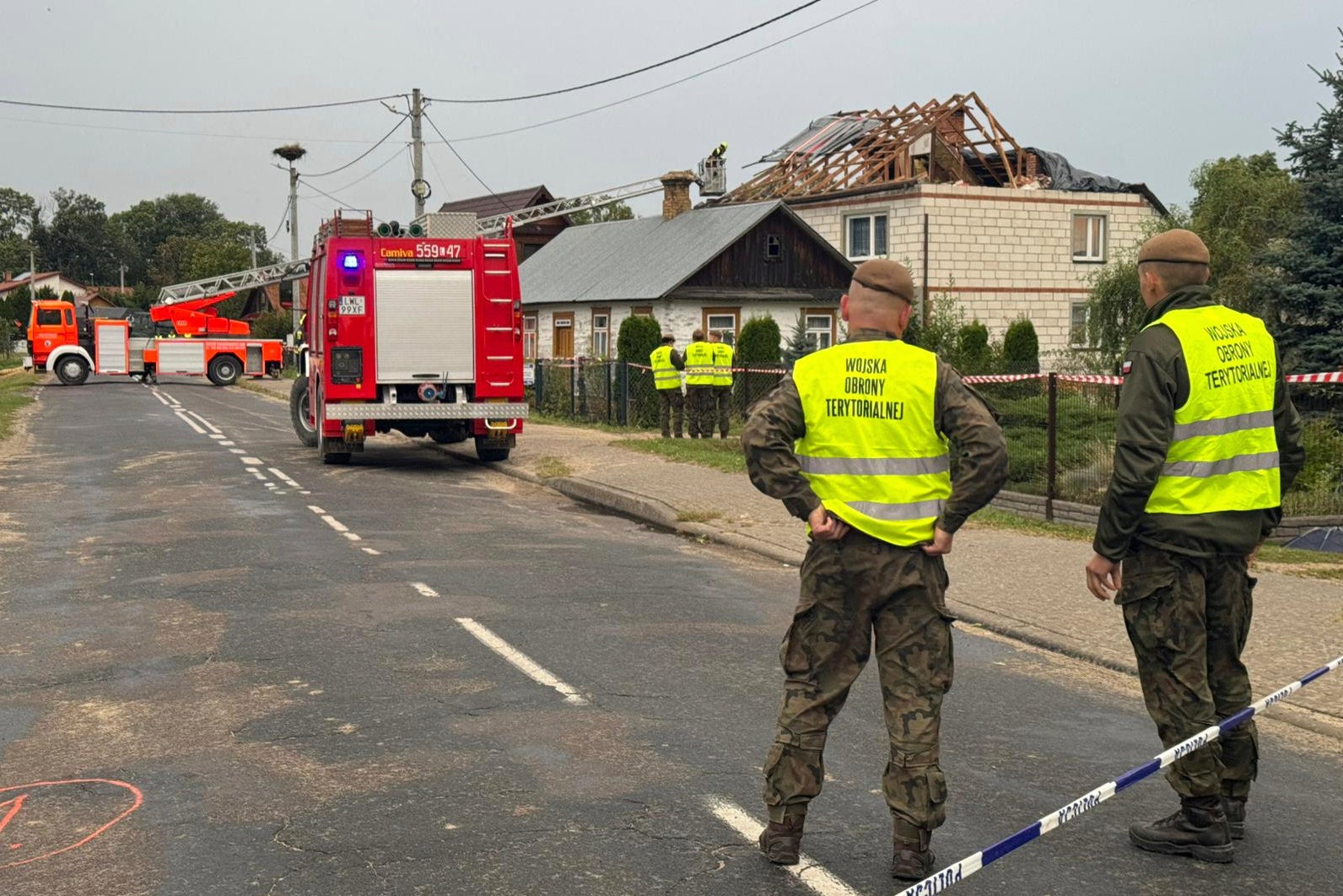 Firefighters and territorial defence officers stand close to the destroyed roof of a house, after Russian drones violated Polish airspace during an attack on Ukraine, in Wyryki near Lublin, Poland, Sept. 11, 2025. (AP Photo/Rafal Niedzielski, File)