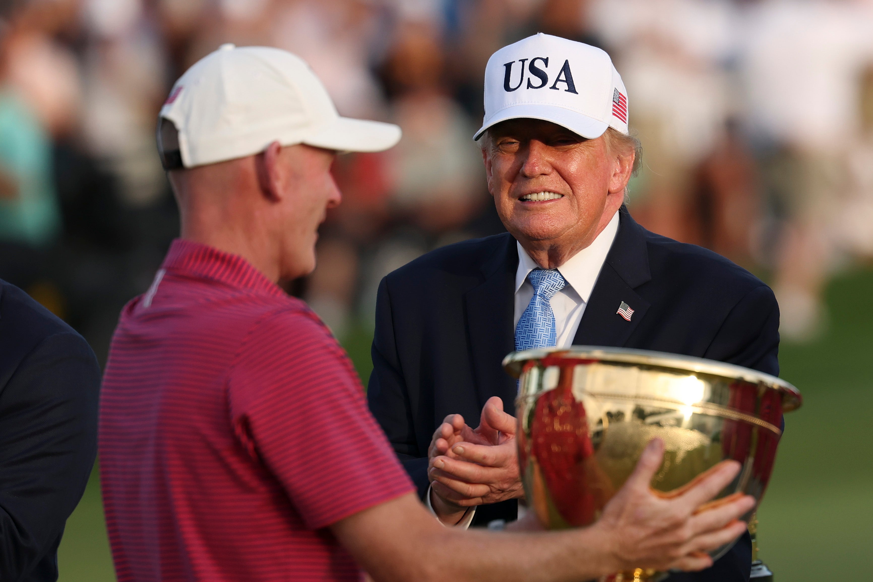 Donald Trump cheered on the golf green as Brandt Snedeker was awarded the President's Cup trophy