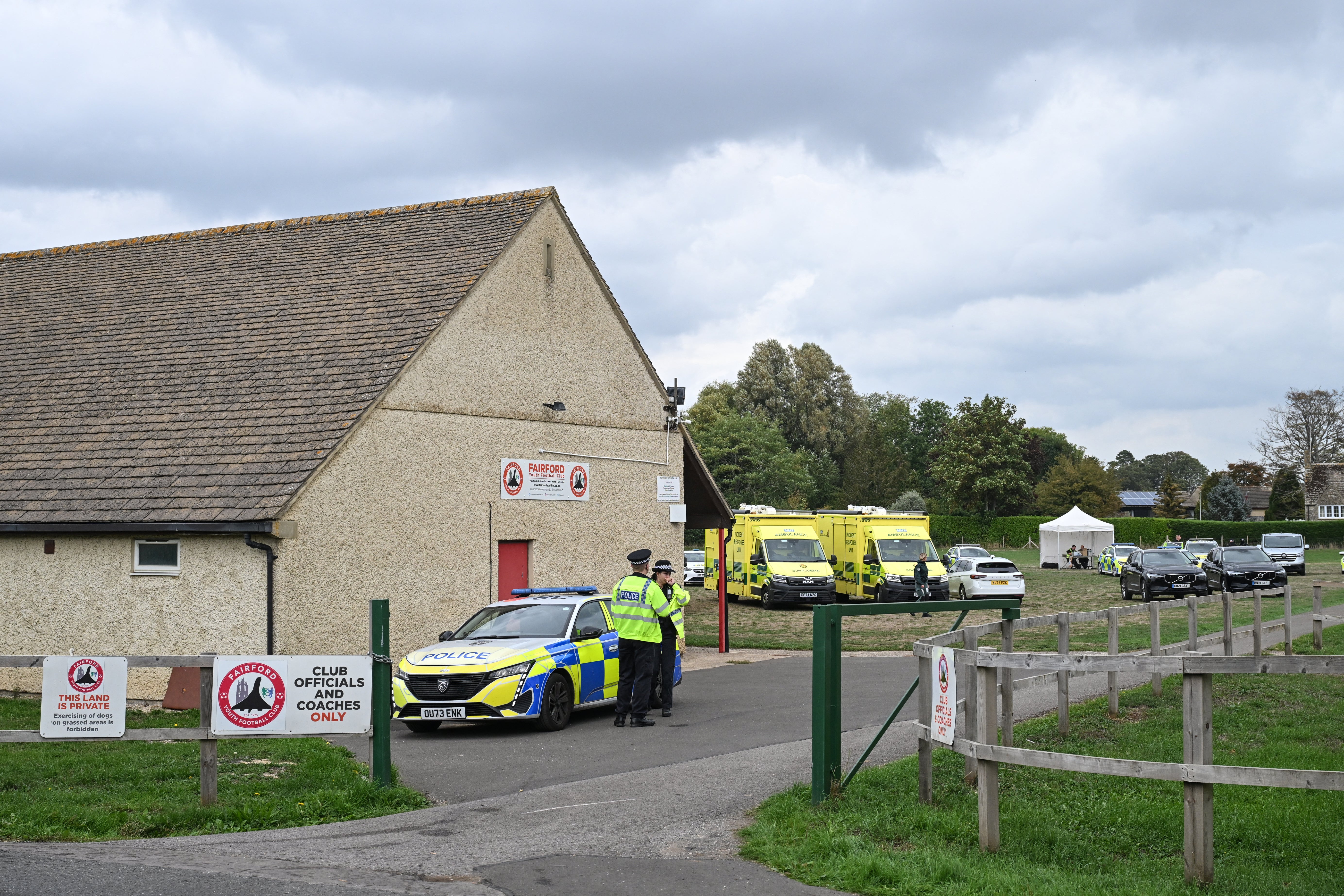 Police stand at the entrance at a base set up at the Fairford Youth Football Club near RAF Fairford base