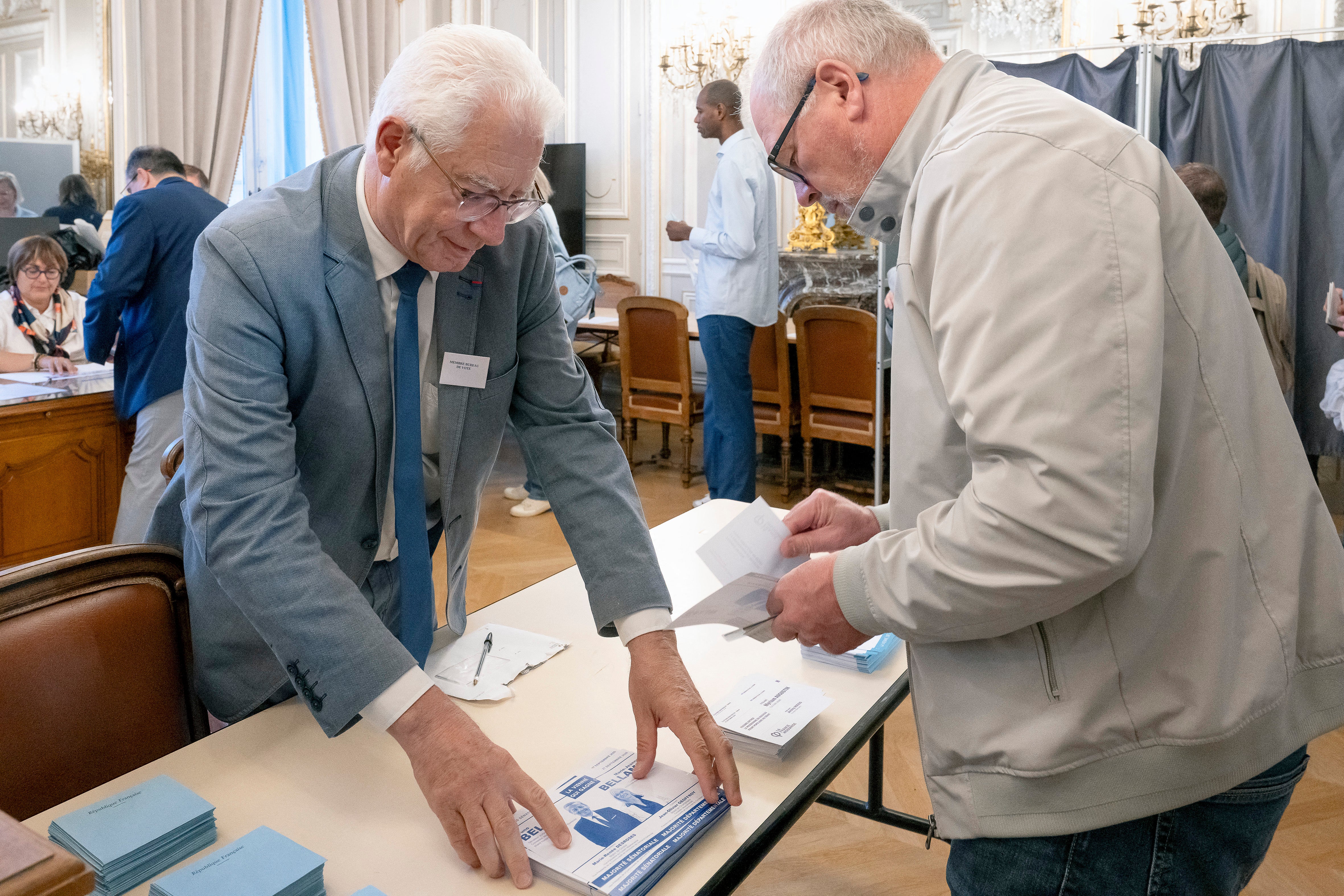 An elected official takes ballot papers from a table in front of a polling station in Poitiers on Sunday (AFP/Getty)