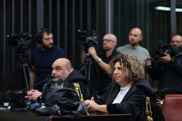 Lawyers for the Egyptian security service members look on