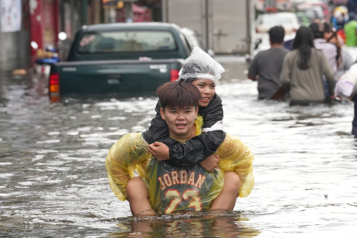 Photos show people navigating Bangkok’s flooded streets during days of heavy rain