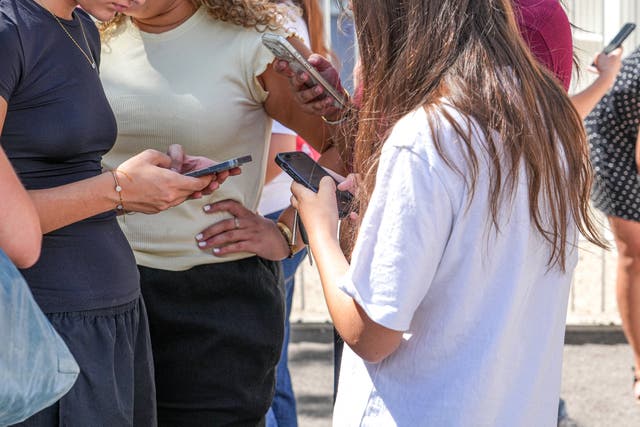 A girl uses her phone in the Spanish Basque city of San Sebastian in February.