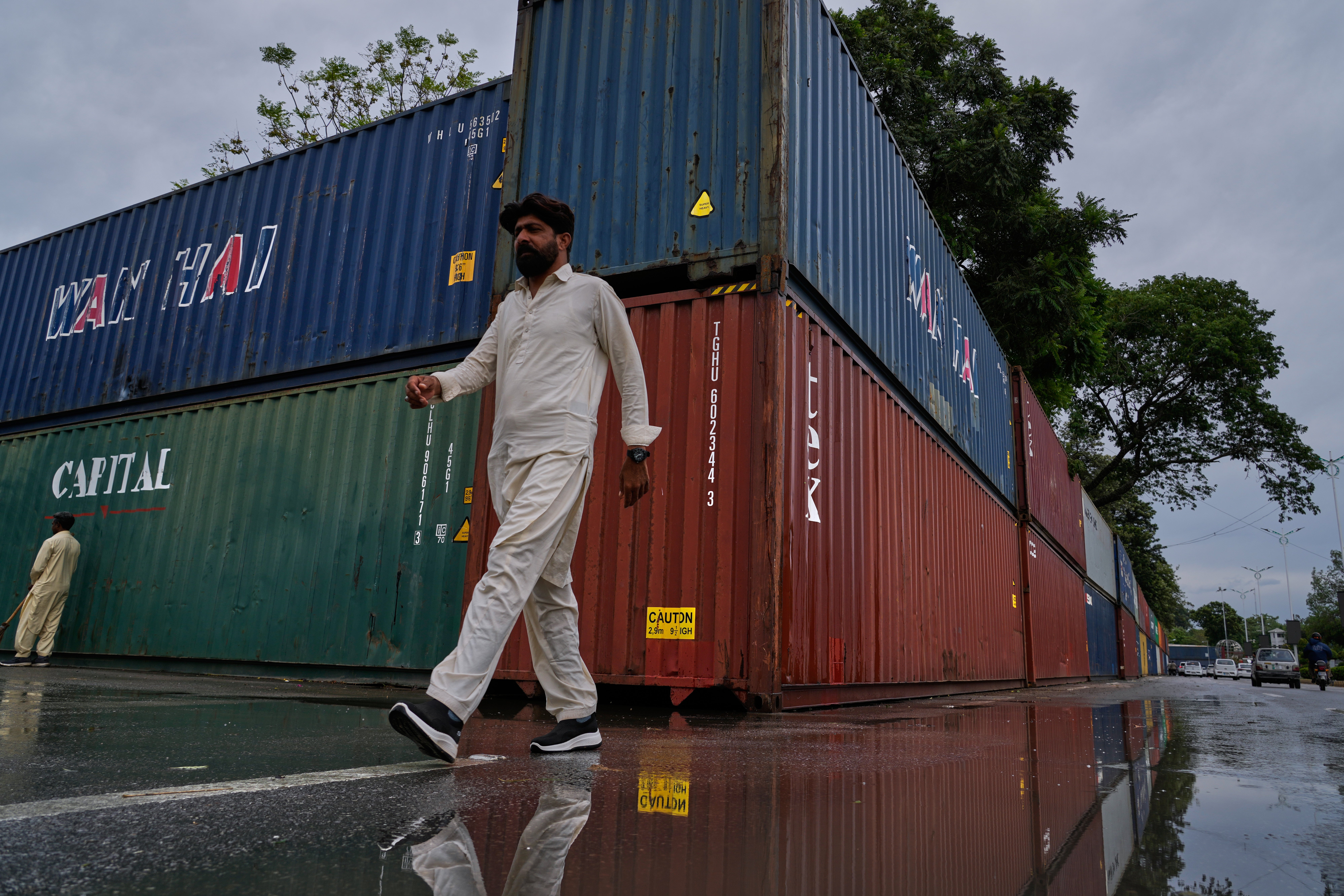 Shipping containers seal off an area ahead of a protest march by supporters of Imran Khan in Islamabad on 28 September 2026 (AP)