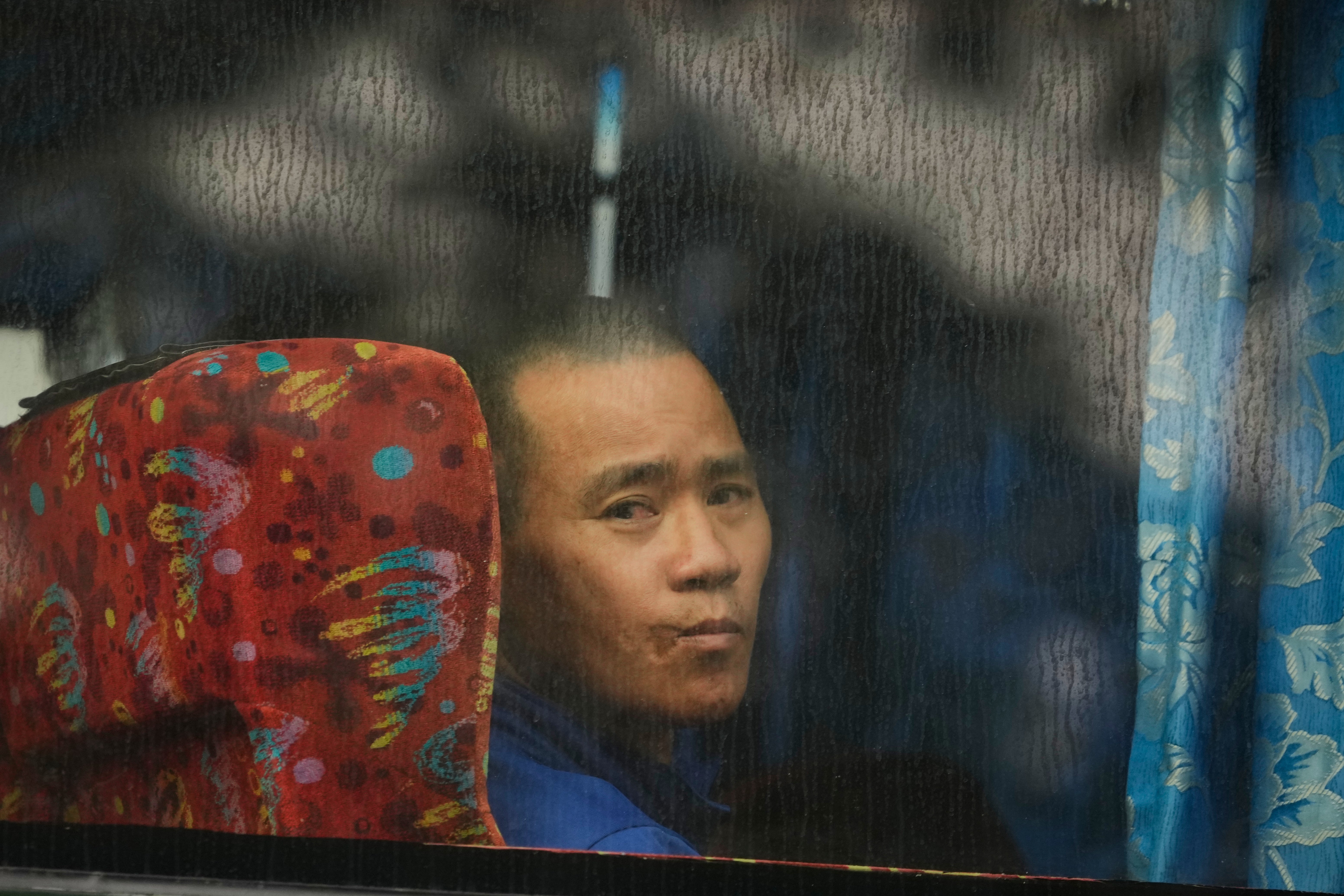 A Myanmarese national being deported looks out from a bus in Manjung, Perak state, Malaysia (AP)