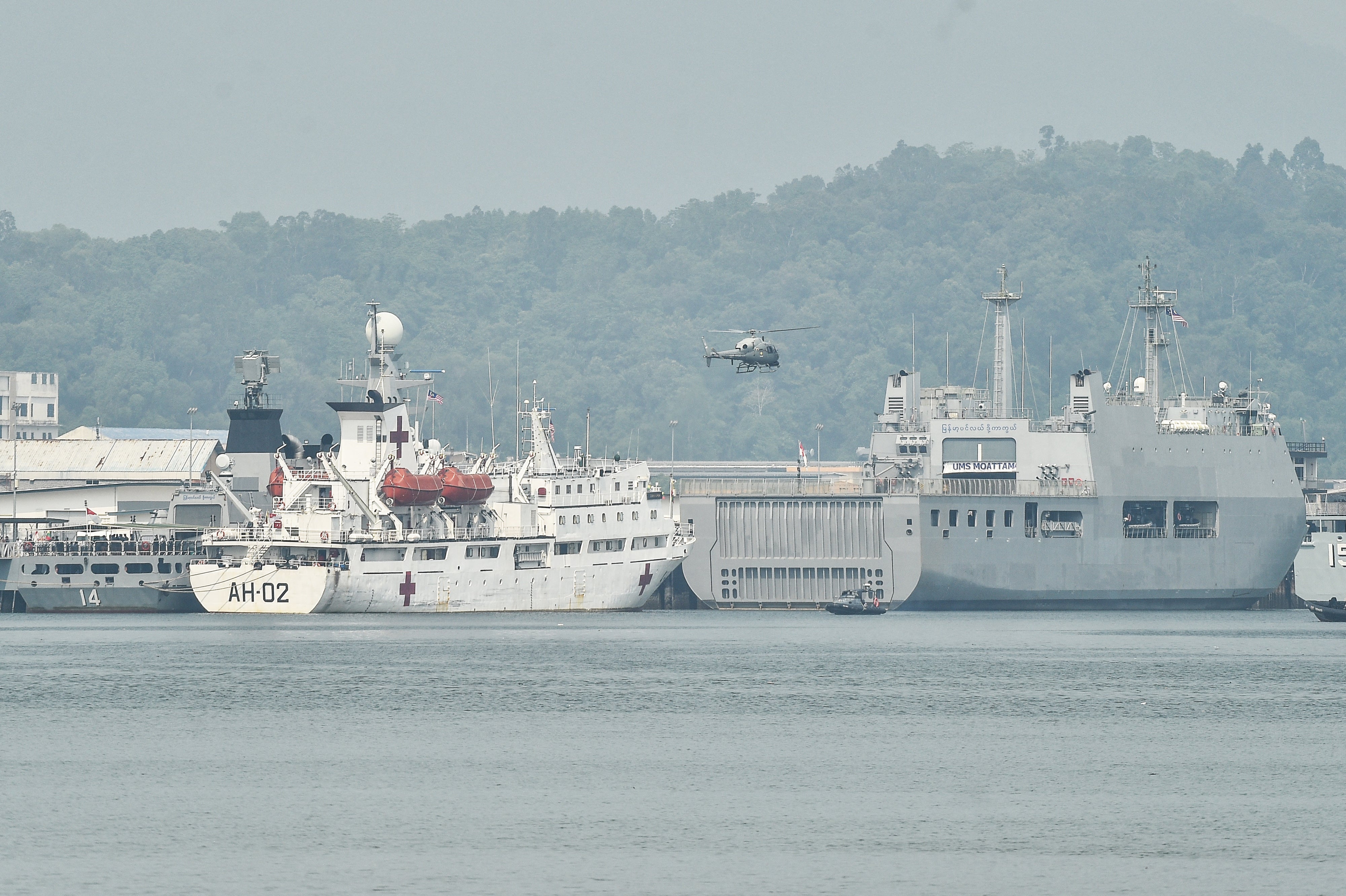 A Malaysian navy helicopter patrols near ships waiting to transport Myanmar nationals at Lumut on the outskirts of Kuala Lumpur (AFP/Getty)