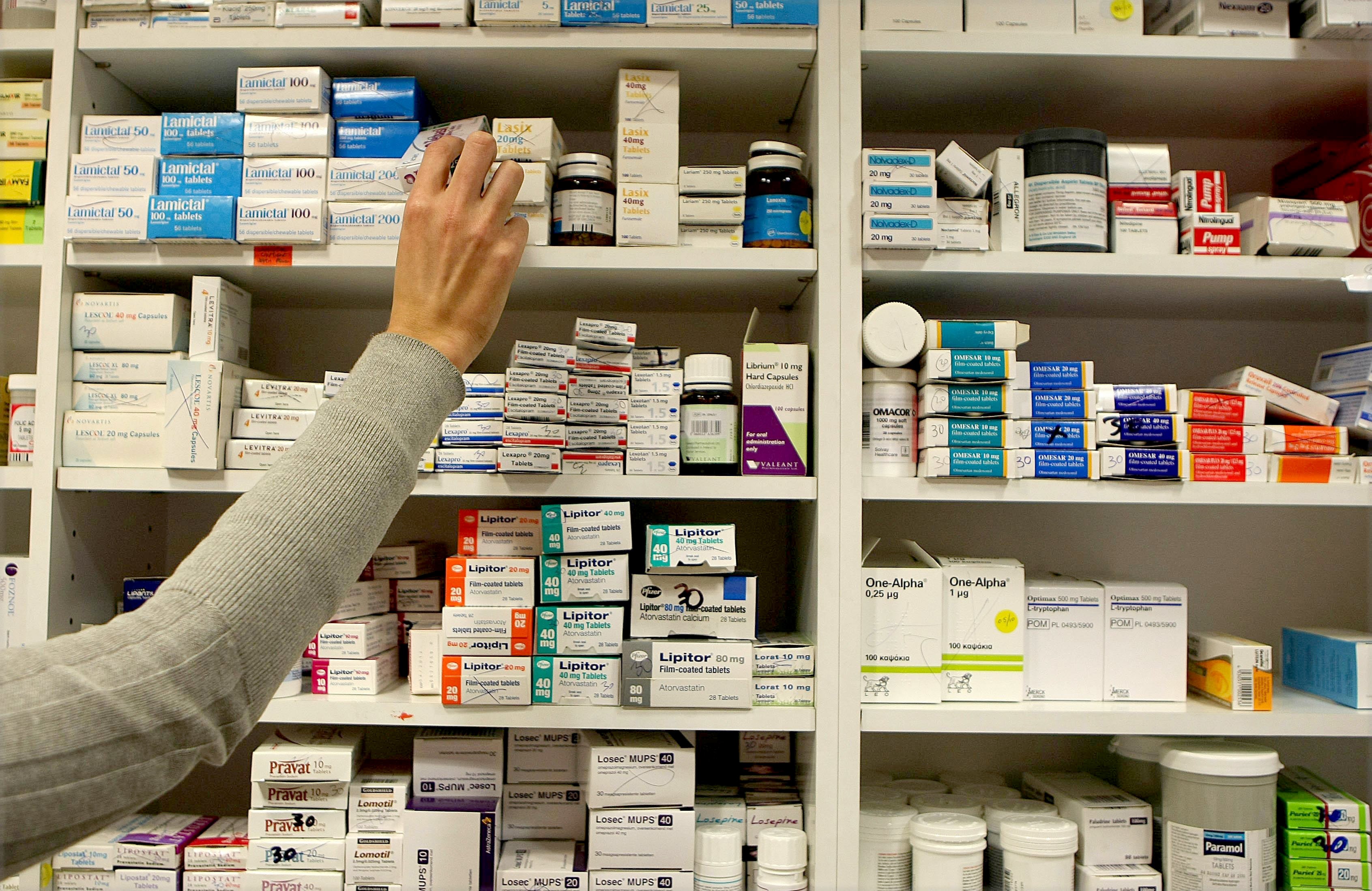 Pharmacist stocking shelves at a chemist