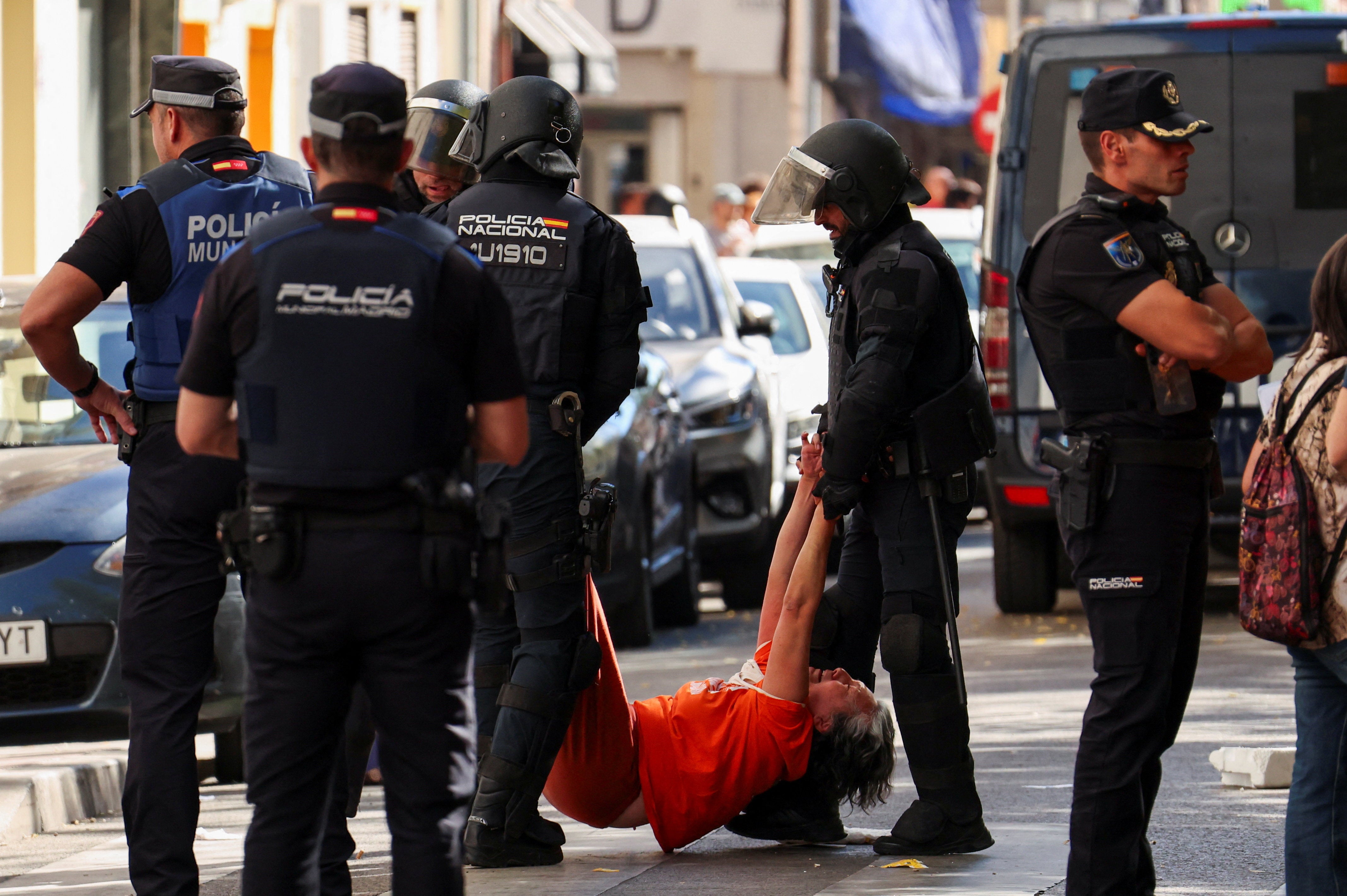 Spanish riot police removes one of the activists, who were trying to prevent the eviction of Maricarmen Abascal, 87