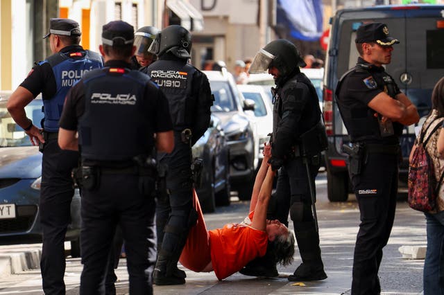 Spanish riot police removes one of the activists, who were trying to prevent the eviction of Maricarmen Abascal, 87
