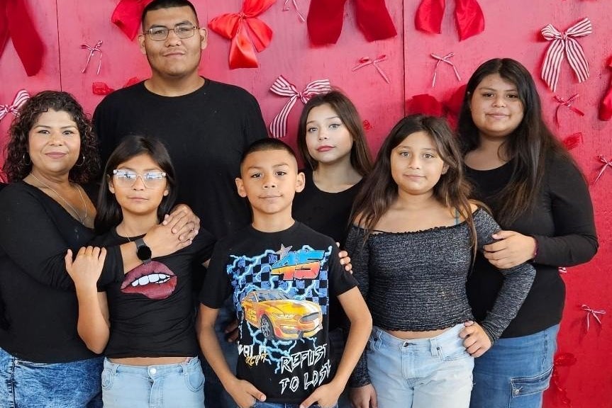 Ramirez, far left, pictured with her six children, says that she now doesn’t go anywhere without her birth certificate. ‘We are from America. This is our home,’ she said (Monique Ramirez)