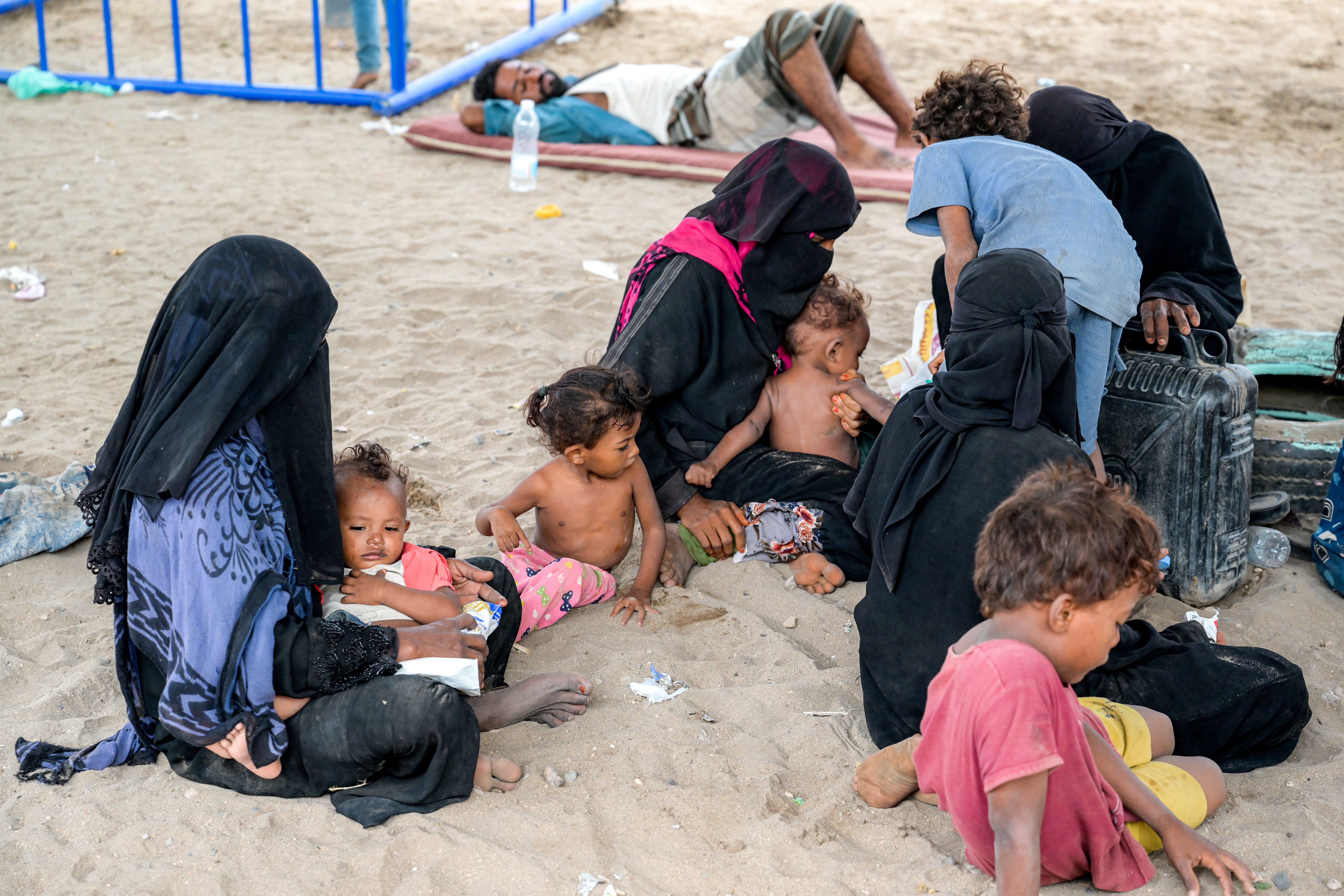 Displaced Yemeni women gather with their children in a displaced persons camp north of Aden earlier this month