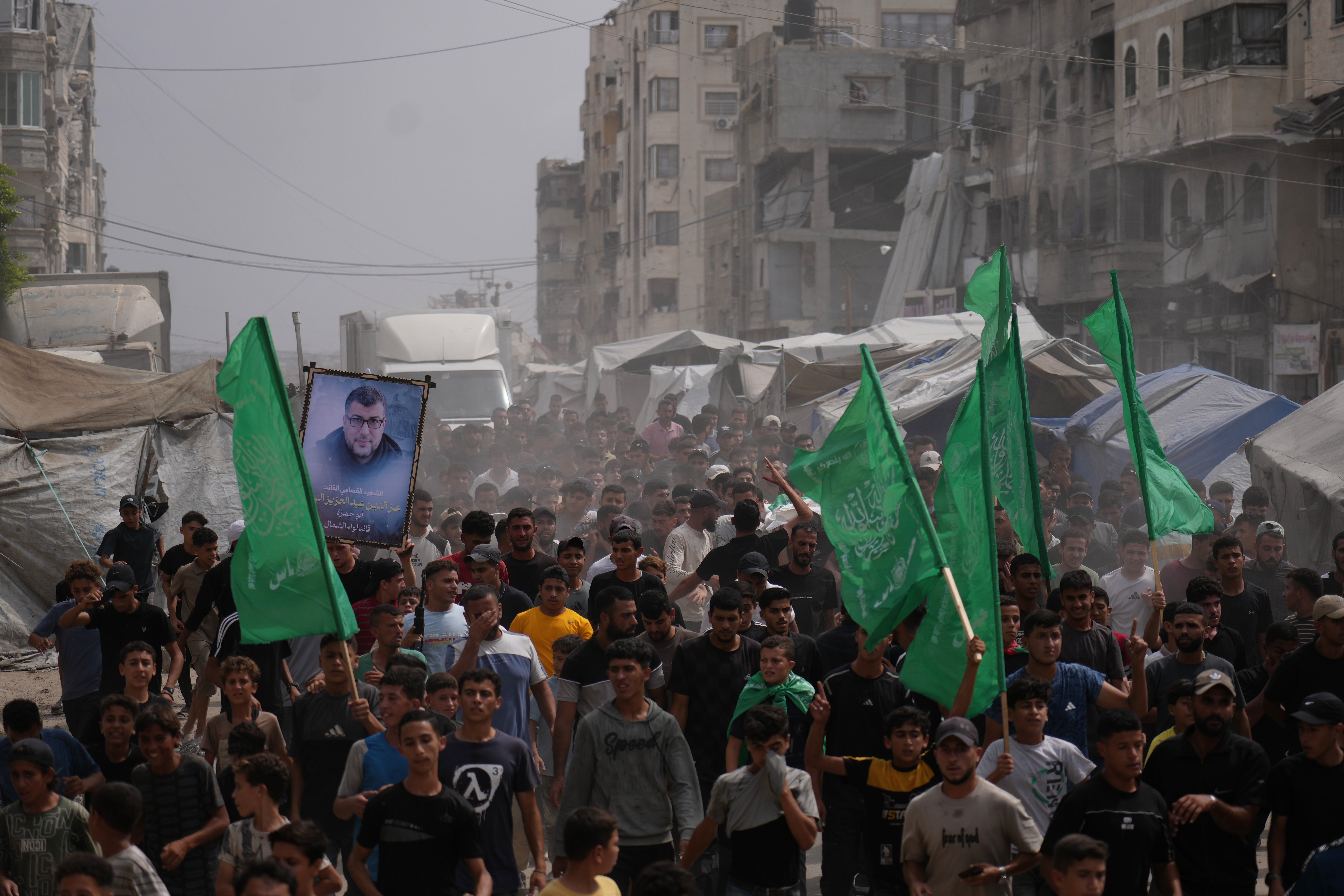 Palestinians carry the bodies of Mohannad Abu Foul and Izz Al Din Al Beik
