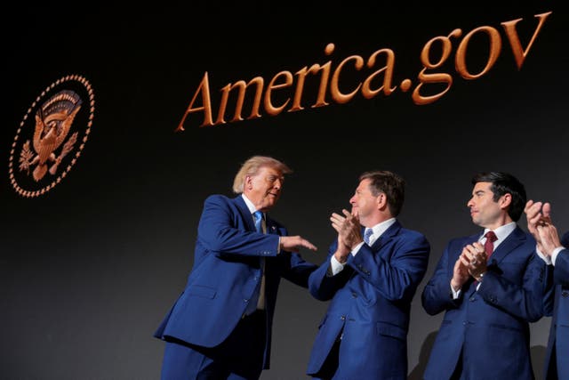 Donald Trump congratulates members of the National Design Studio at the launch of America.gov