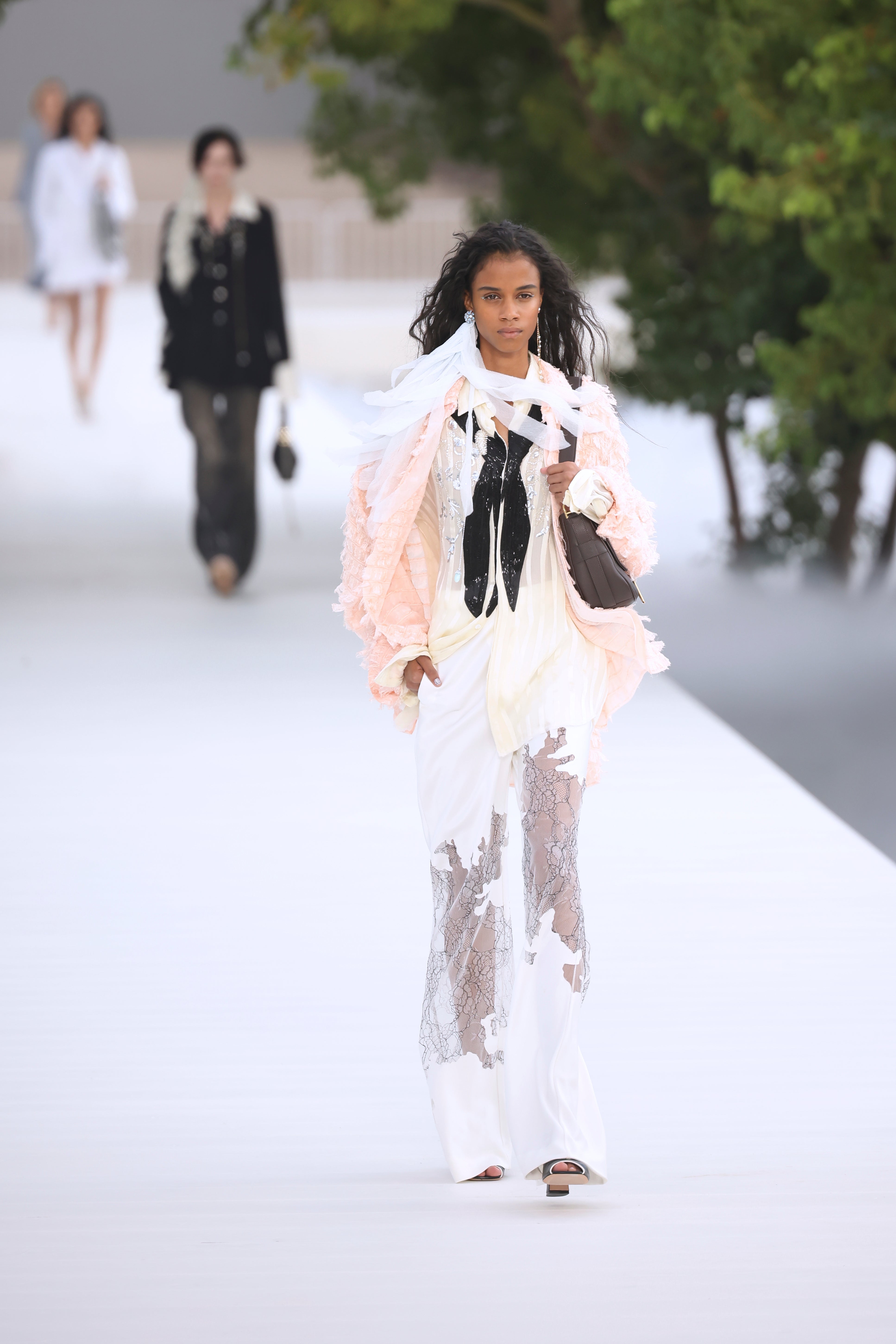 Lightweight ruffles and petal accents fluttered on the outside runway (Thomas Padilla/AP) (AP)
