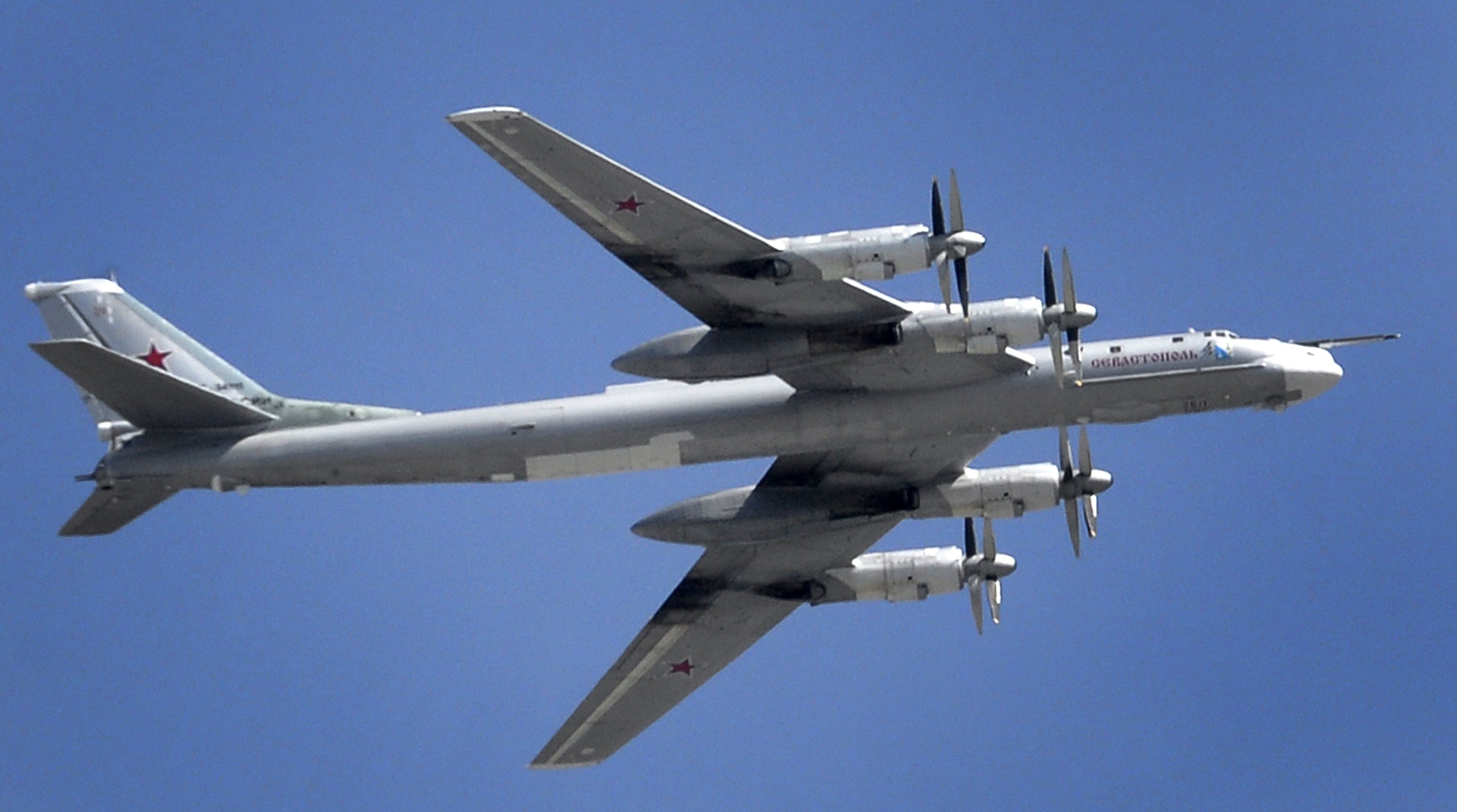 A Russian Tupolev Tu-95 turboprop-powered strategic bomber flies above the Kremlin in Moscow, on May 7, 2015