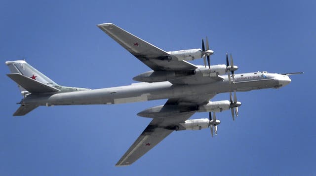 A Russian Tupolev Tu-95 turboprop-powered strategic bomber flies above the Kremlin in Moscow, on May 7, 2015