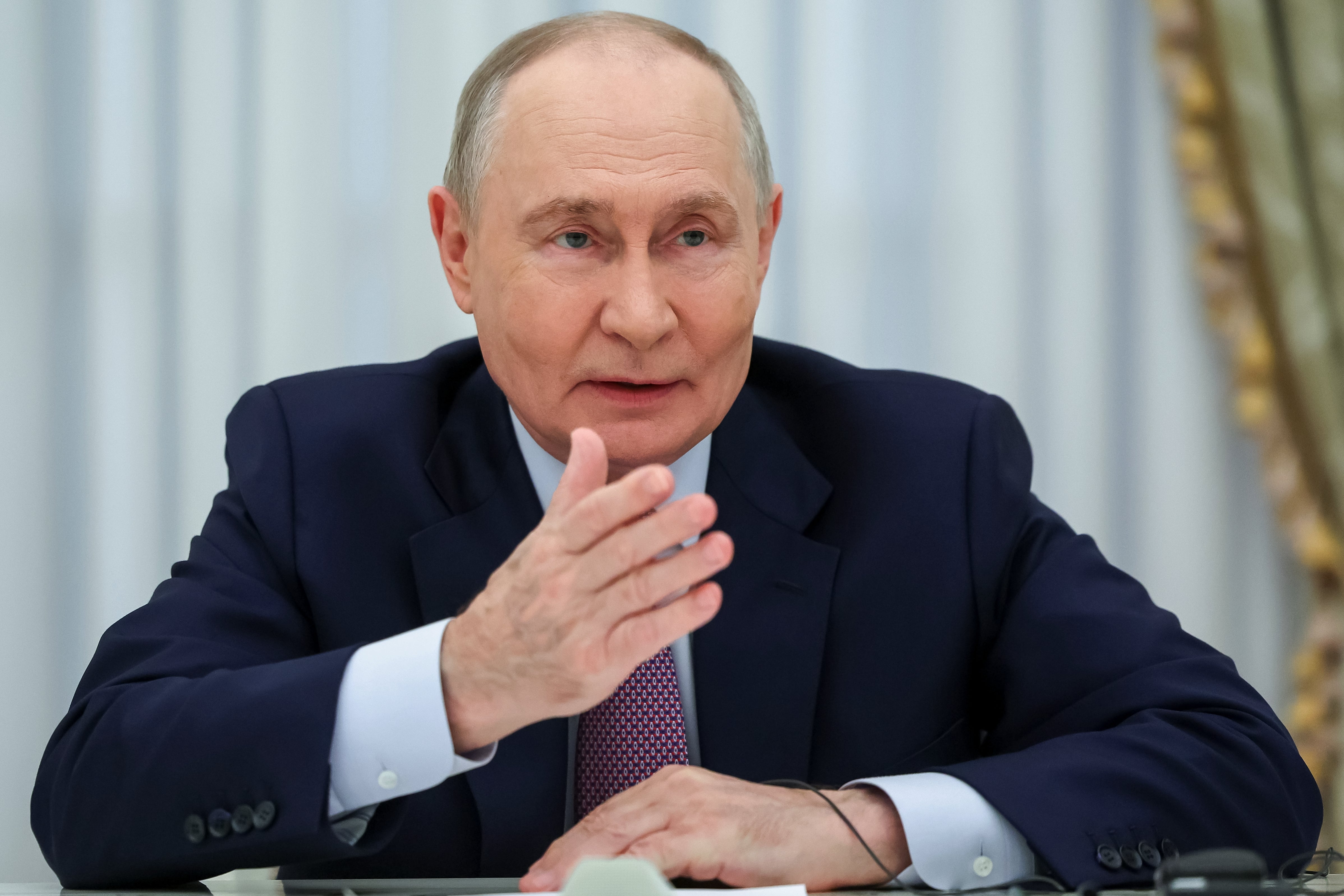 Russian president Vladimir Putin gestures while speaking to Bosnian Serb leader Milorad Dodik during their talks at the Kremlin in Moscow, Tuesday, 29 September (AP)