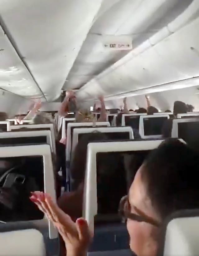 Passengers on the flight applaud after the plane landed in Saudi Arabia
