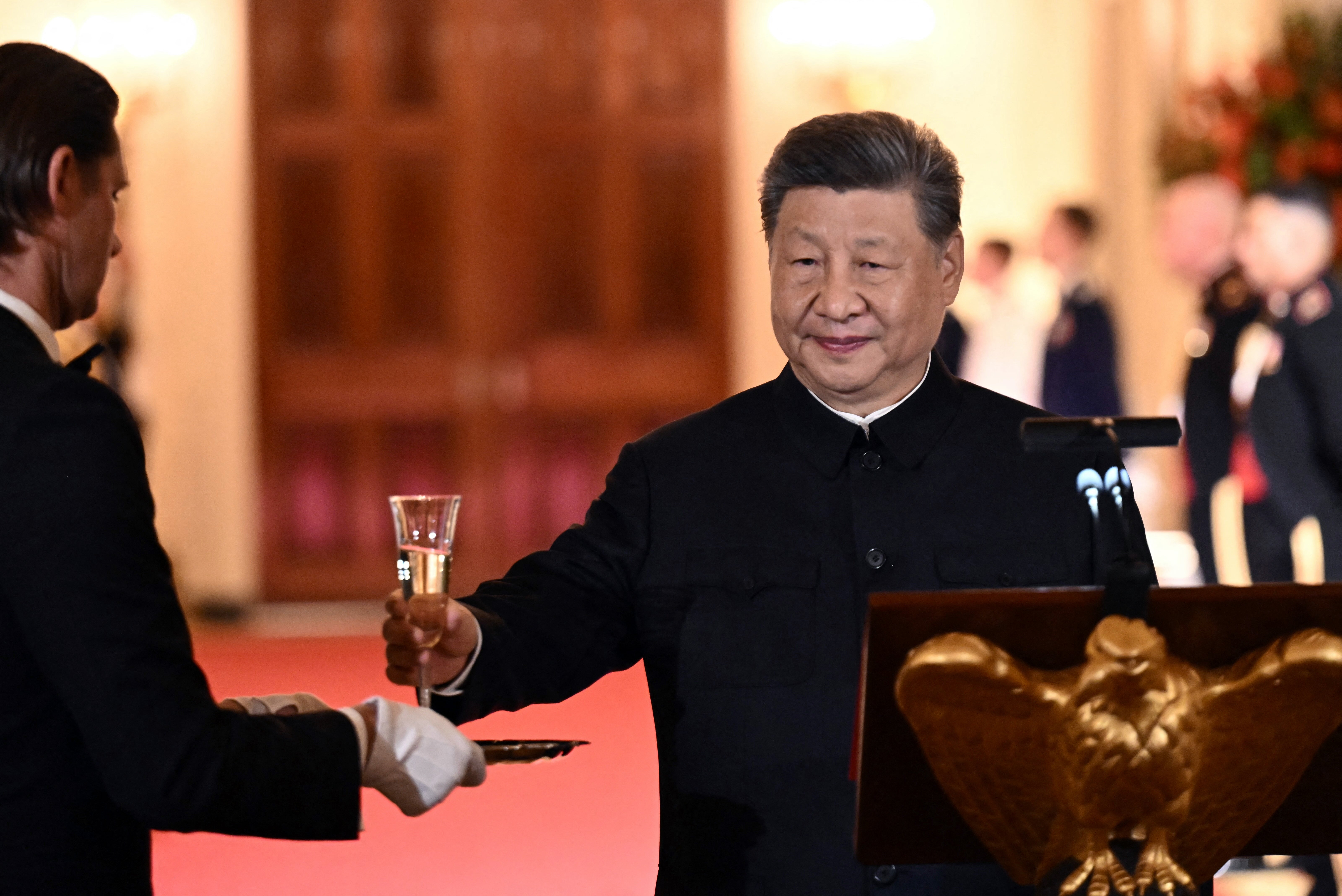 President Xi Jinping grabs a glass to propose a toast during a state dinner hosted by US president Donald Trump at the White House in Washington (AFP/Getty)