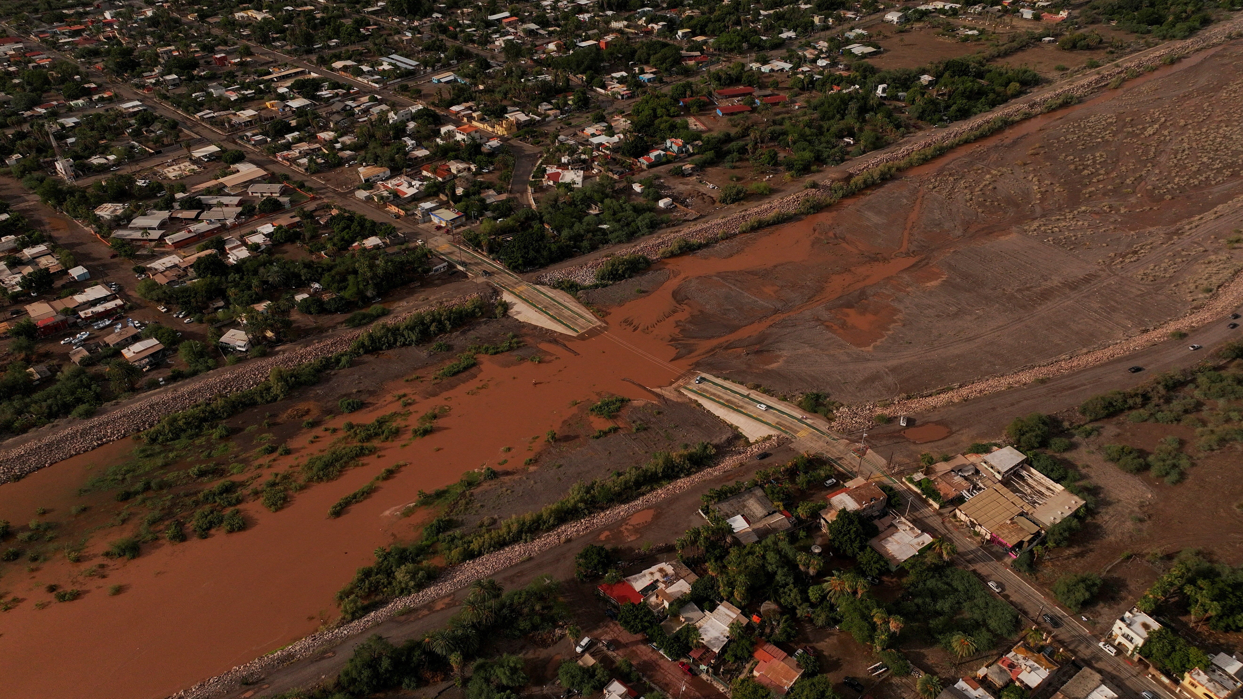 A drone view shows a section of a road submerged in a stream, after Hurricane Polo made landfall in Baja California Sur.