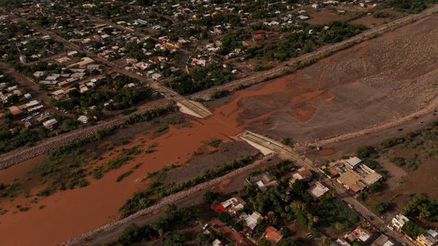 A drone view shows a section of a road submerged in a stream, after Hurricane Polo made landfall in Baja California Sur.