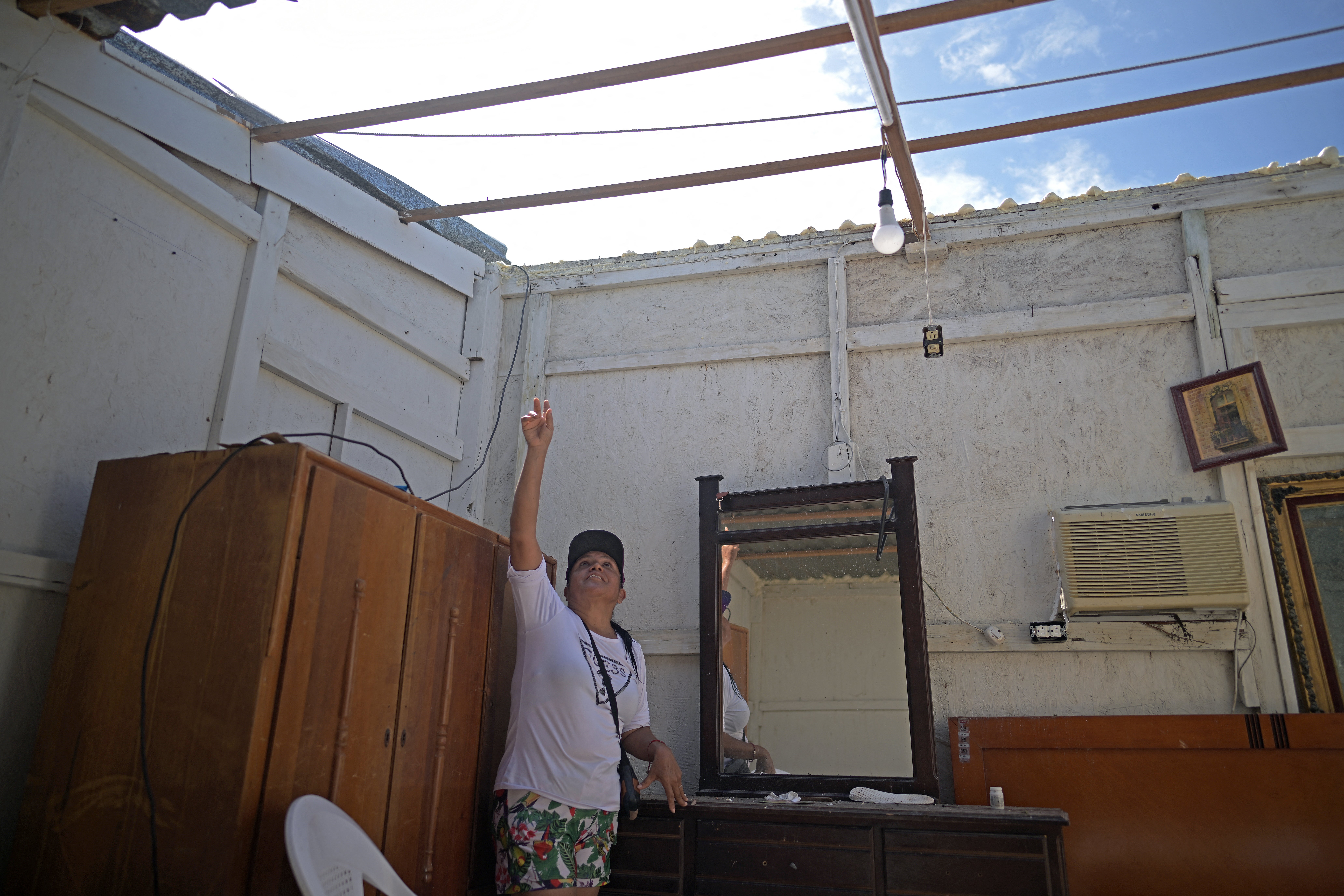 Resident Elvira Sanchez shows her house, which lost its roof, in the town of Puerto Adolfo Lopez Mateos, Baja California Sur state, Mexico.