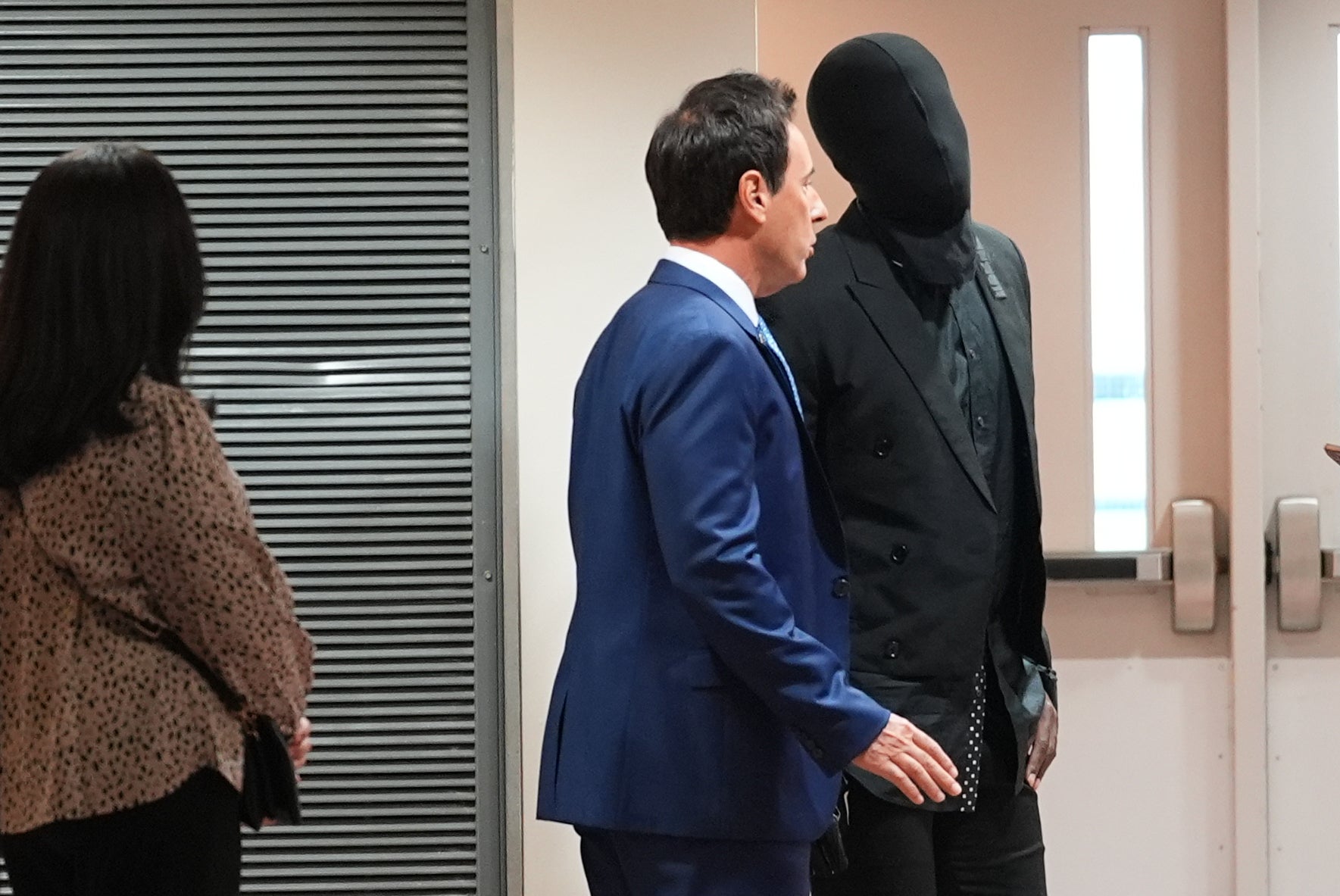 Former NFL player Antonio Brown wears a hood over his face as he speaks with his attorney Mark Eiglarsh before a court hearing Wednesday, Sept. 30, 2026, in Miami (AP)