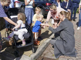 Kate helps one-year-old Albie Botley-Greenslade jump from a kerb in Pulborough, West Sussex