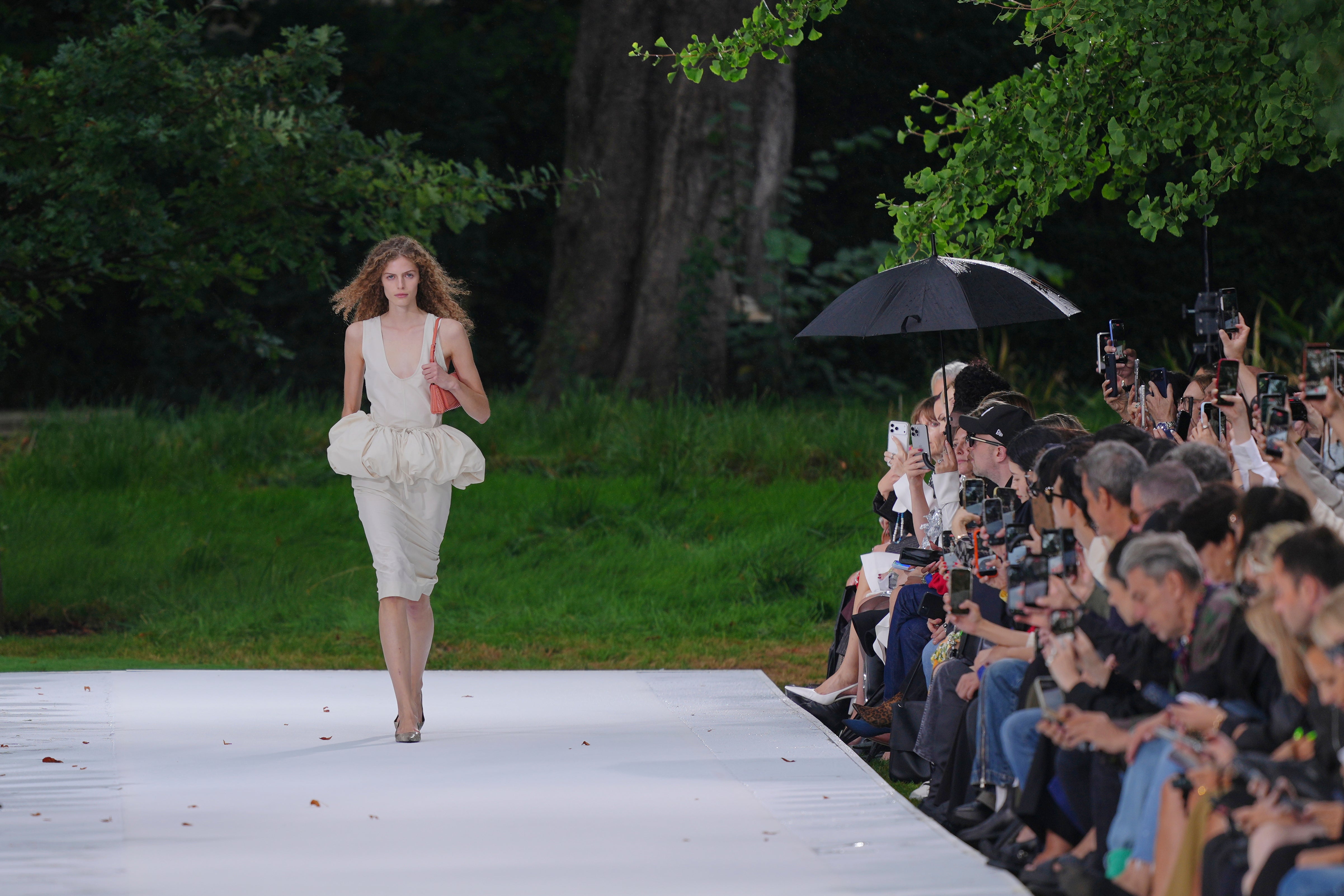 The opening look was a scoop-necked midi dress with a ruffled peplum (Aurelien Morissard/AP) (AP)